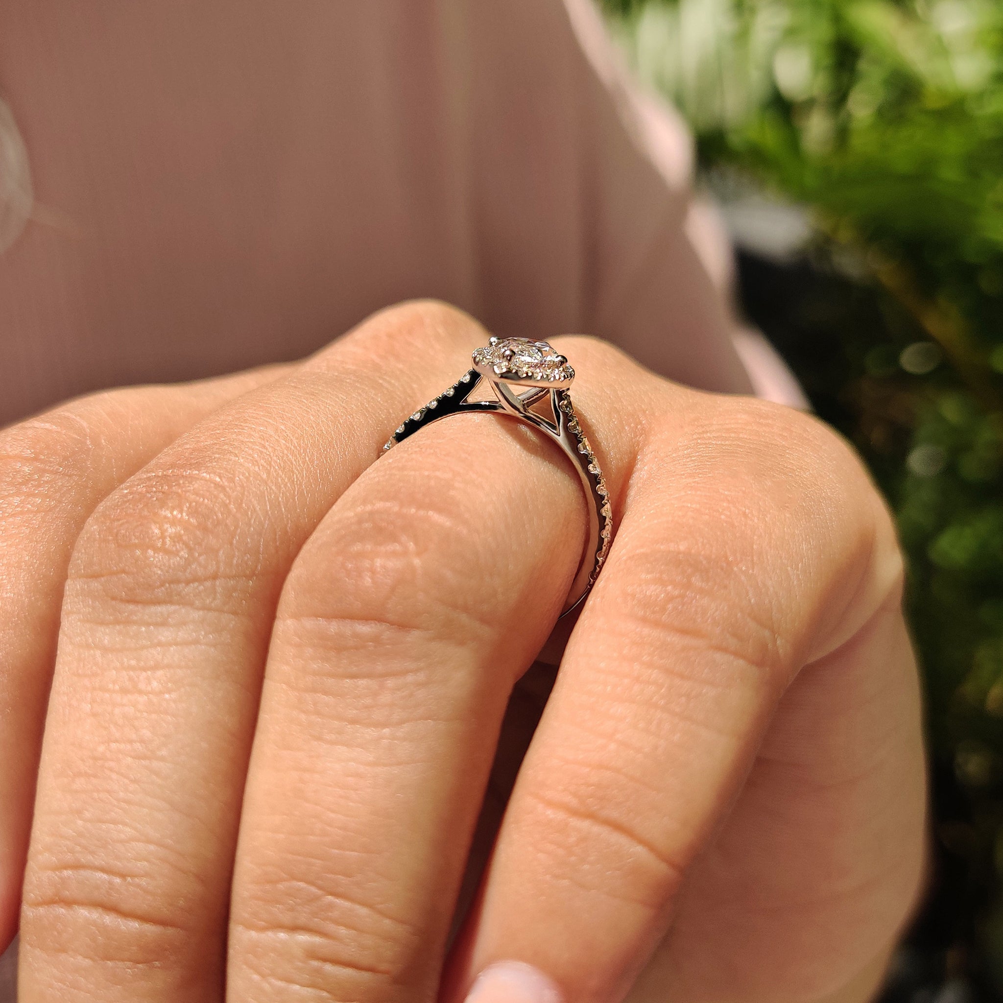 White gold engagement ring with halo design.
