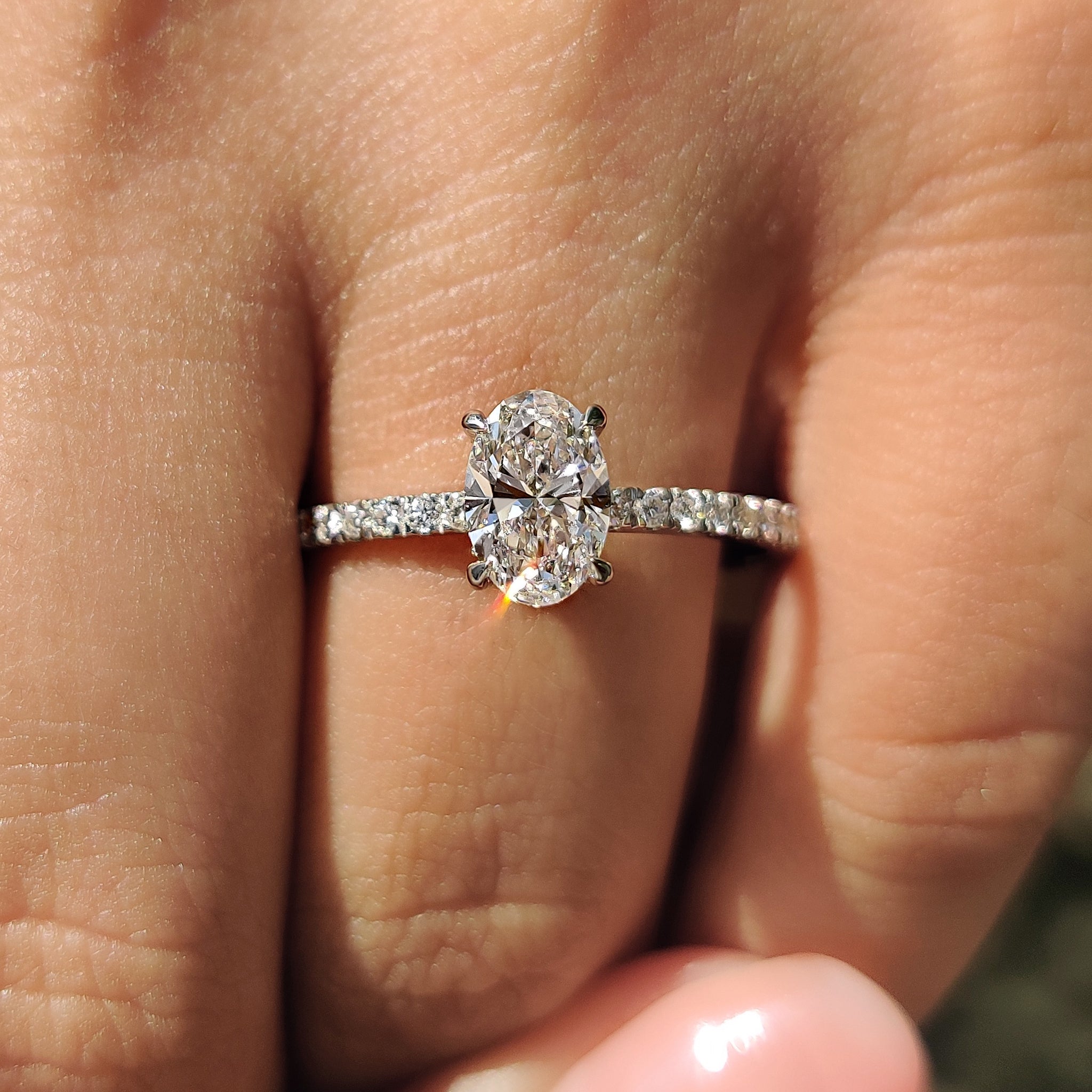 Hidden halo setting with round pave accents.