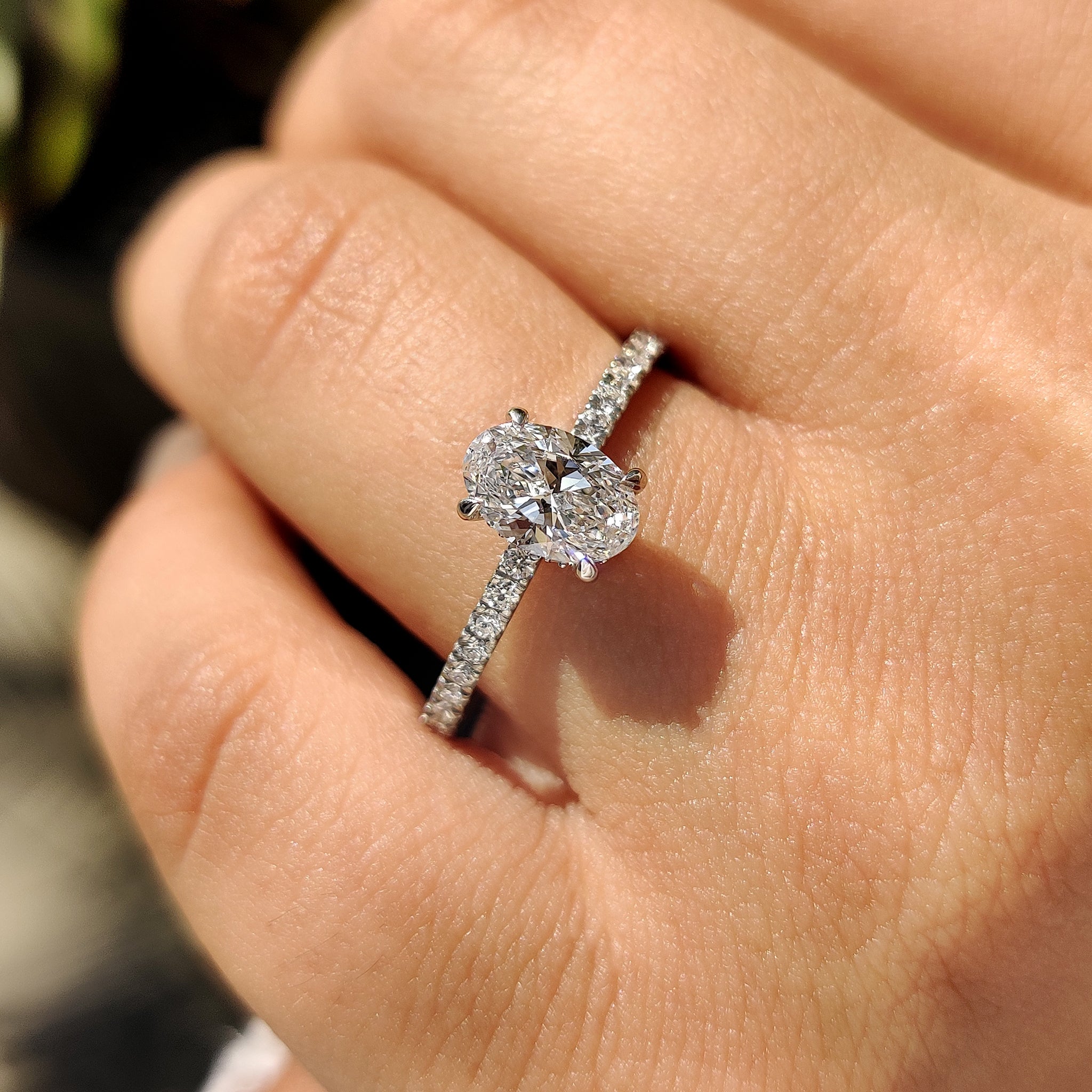 Handmade ring with hidden halo and claw prongs.