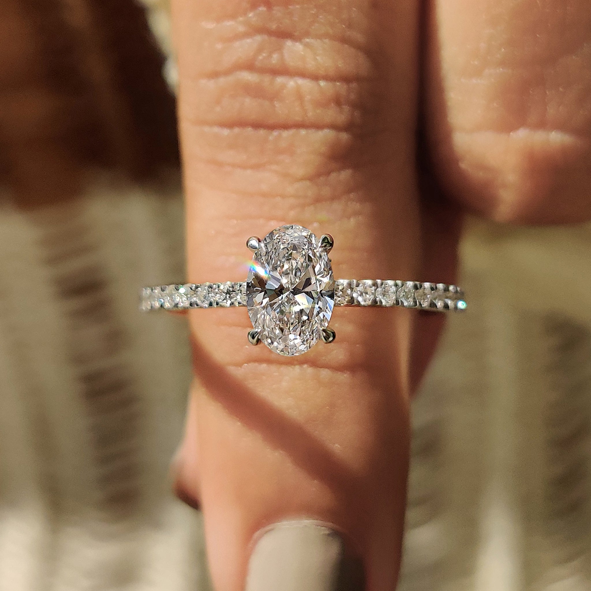 Oval diamond engagement ring with hidden halo.