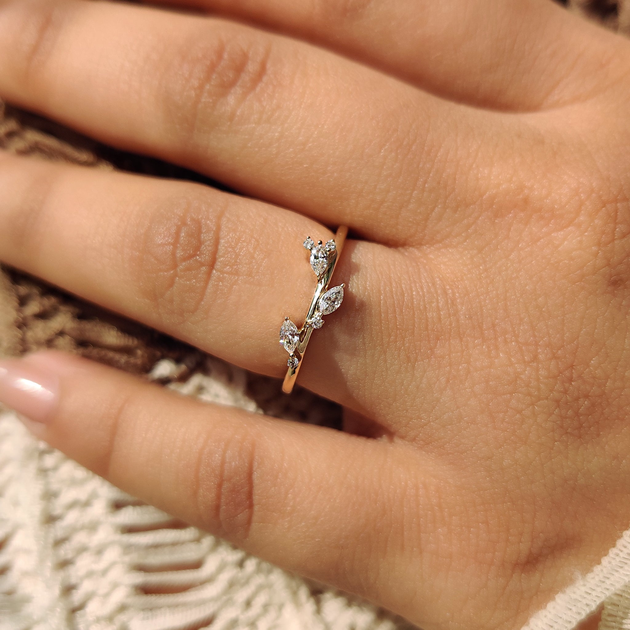 Custom wedding band with marquise diamond and round diamond details.