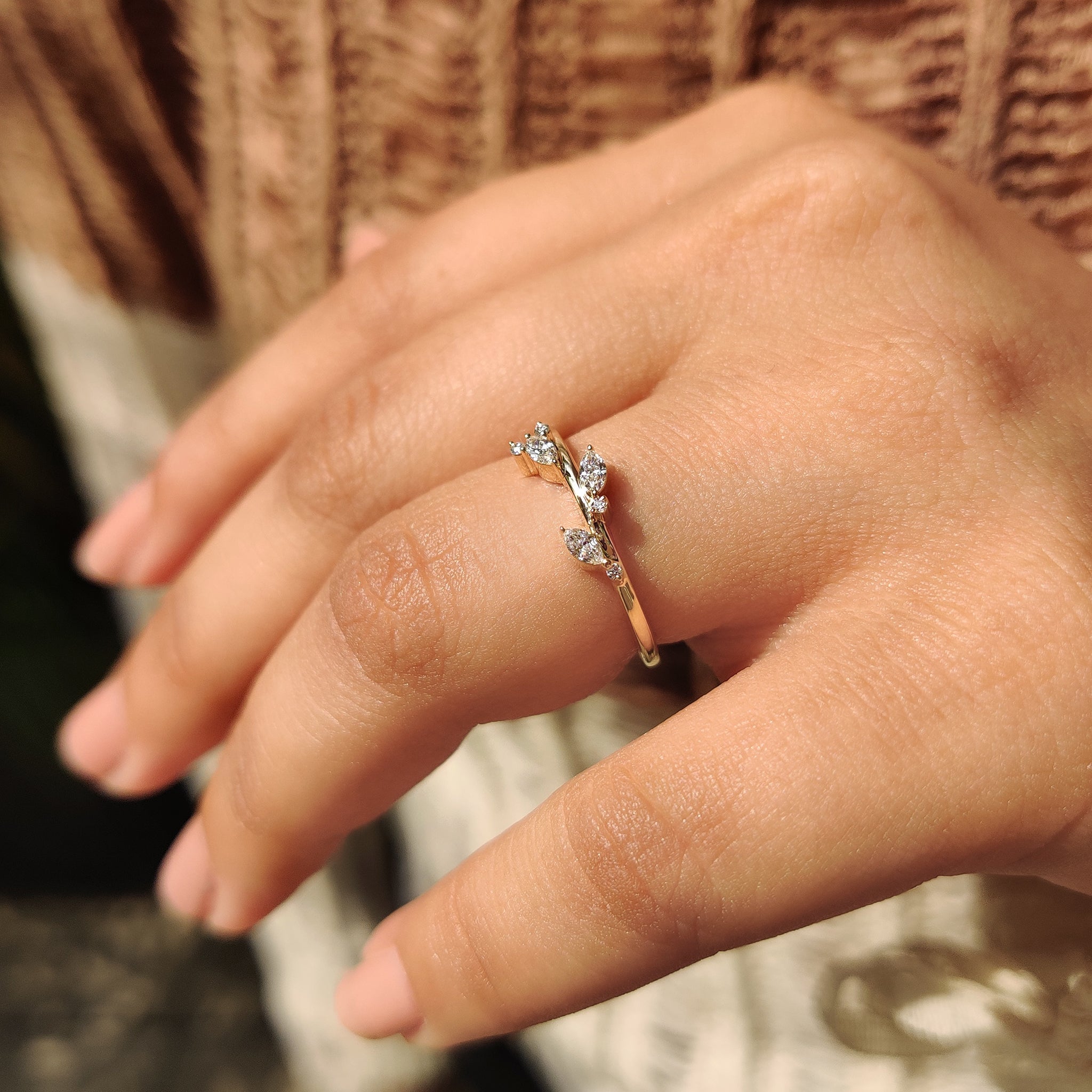 Minimalist wedding ring with marquise and round diamonds in yellow gold.