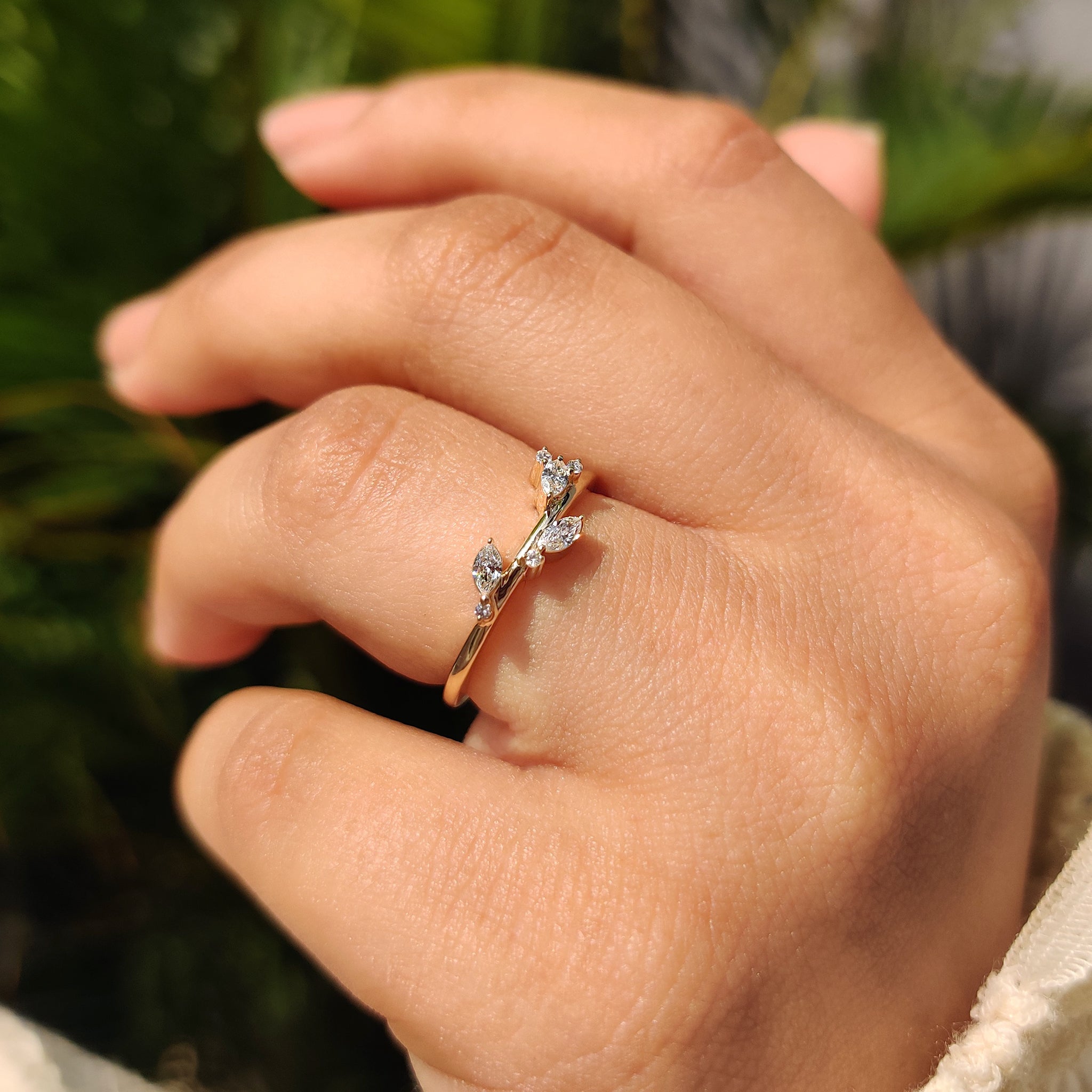 Cluster wedding band with marquise diamond and round diamond accents.