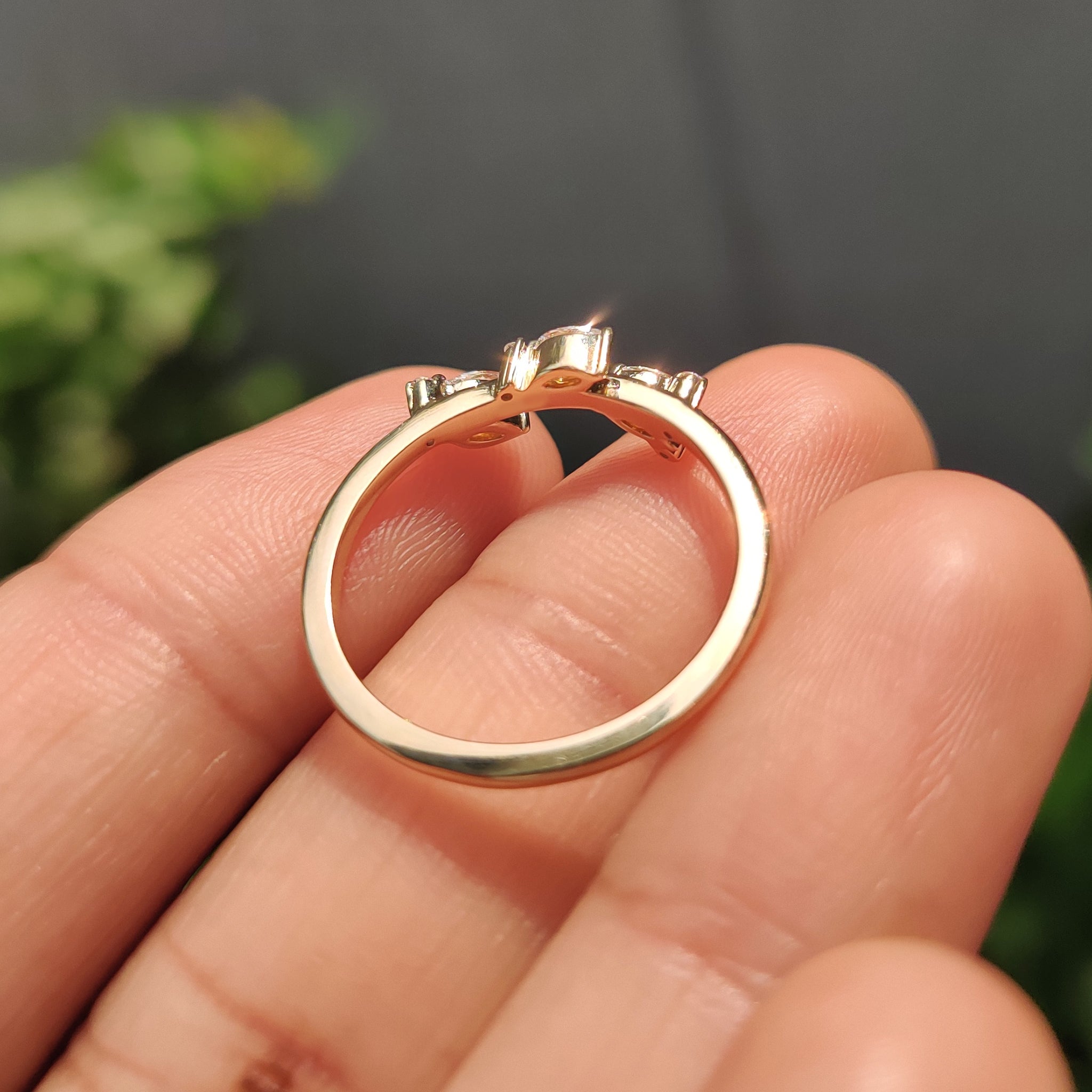 Seven diamond wedding band in yellow gold with marquise and round stones.