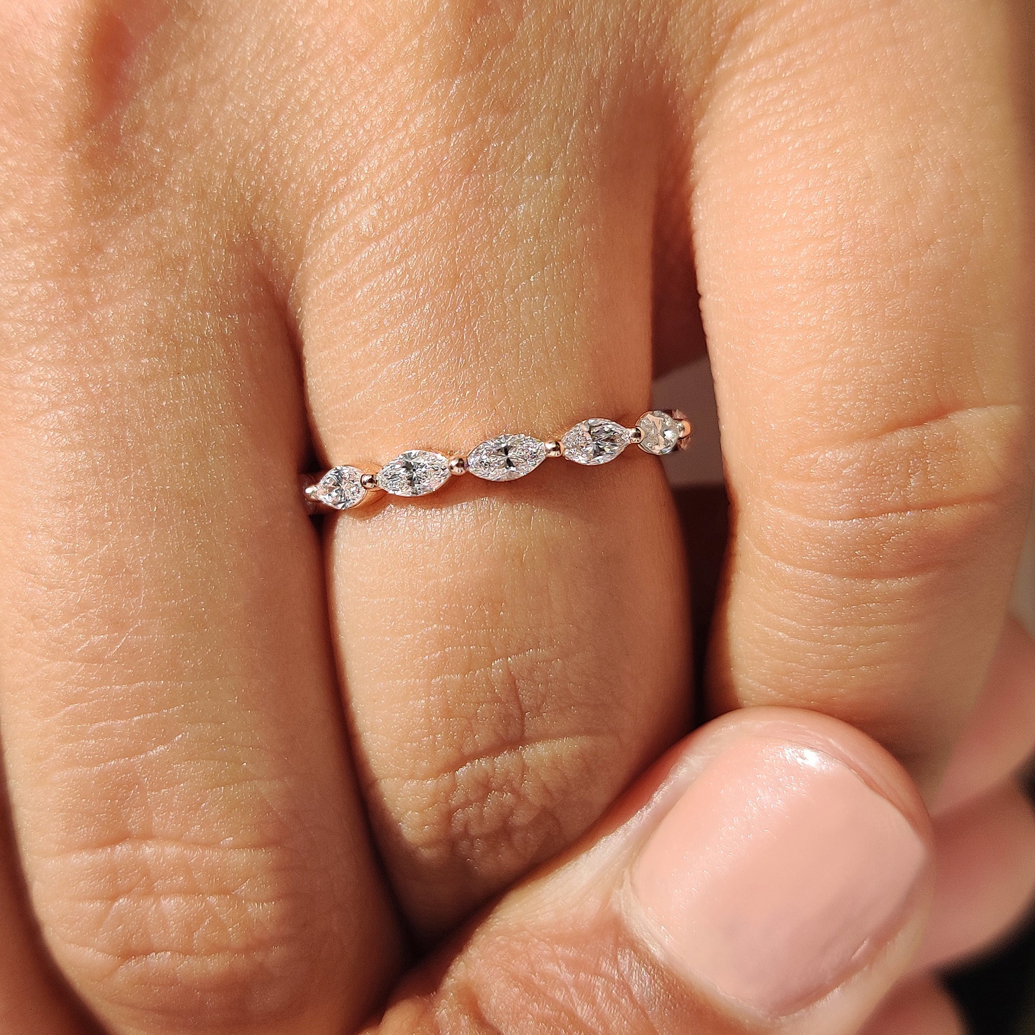 Buy wedding band with marquise diamond and shared prong setting style.
