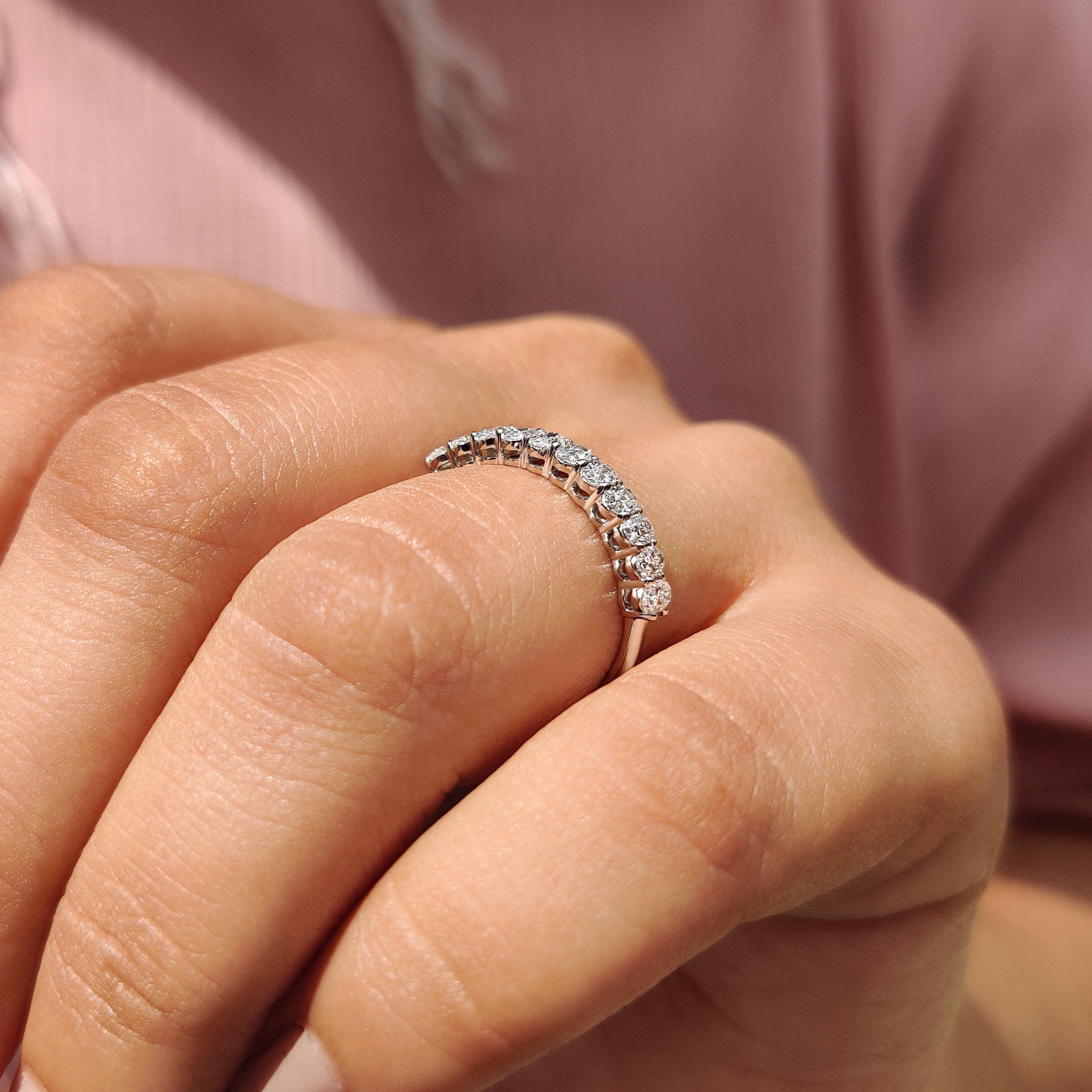 Custom wedding band with carat diamonds band and shared prong setting.
