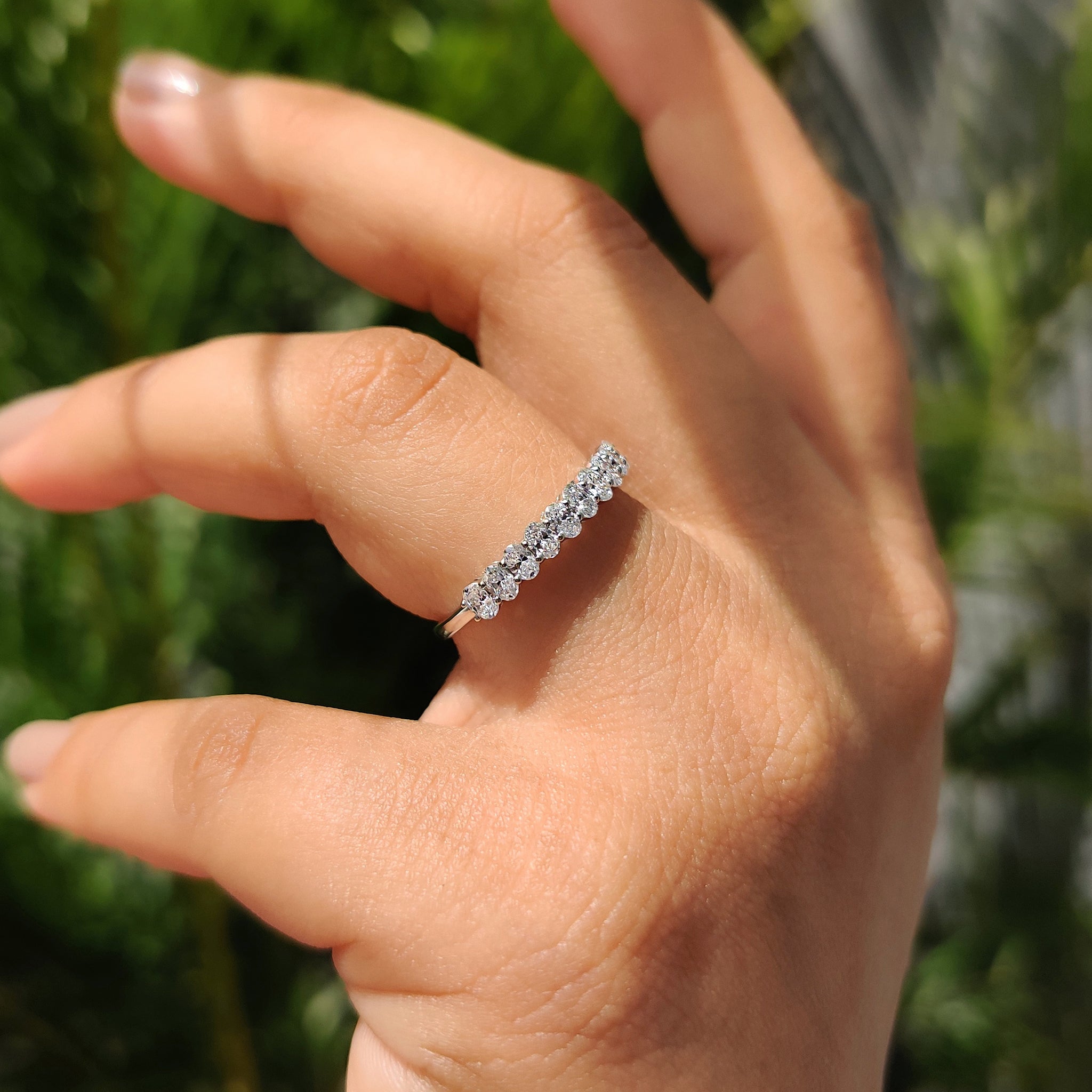 Semi eternity diamond wedding band with shared prong set and handmade jewelry.