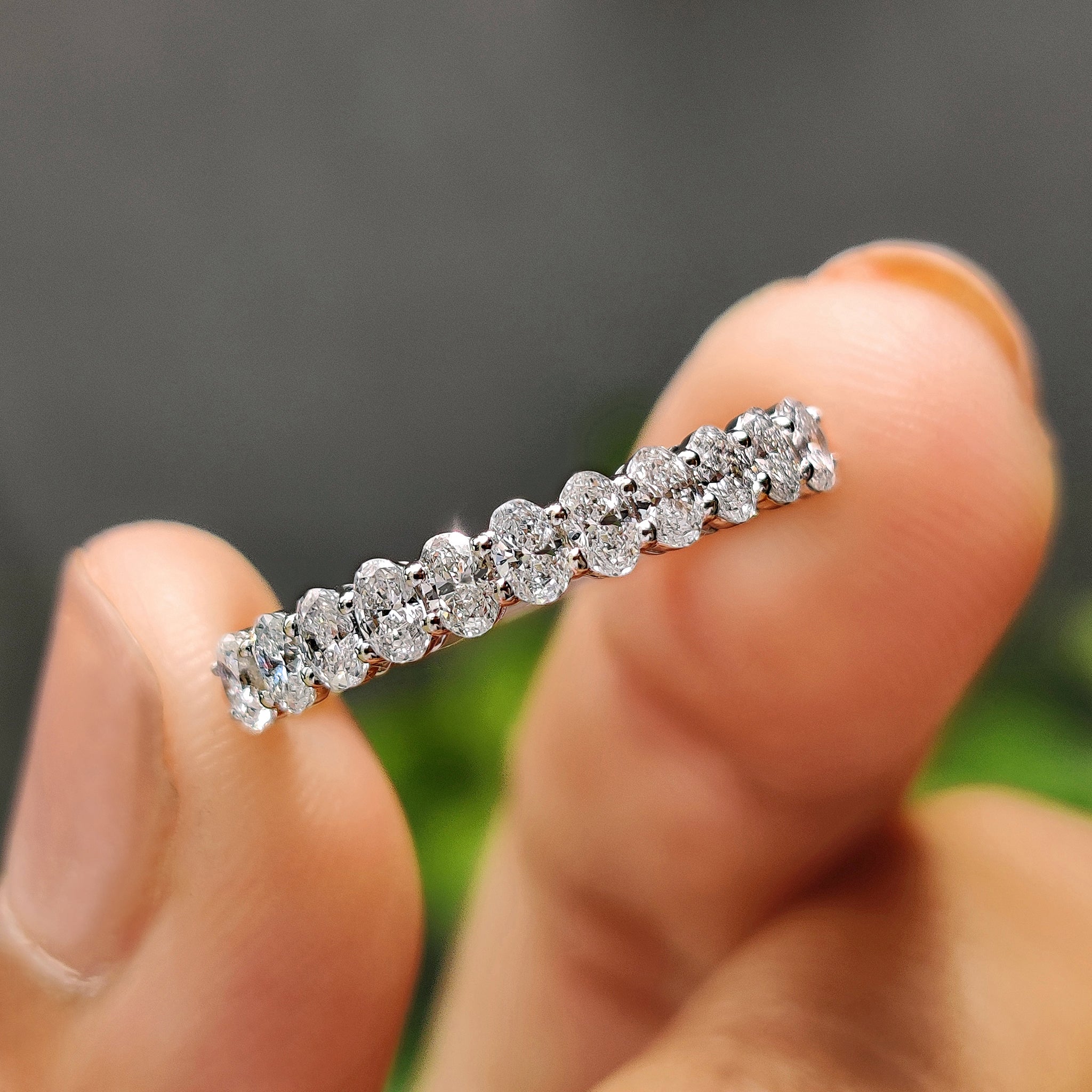 Oval diamond wedding band with shared prong set in white gold.
