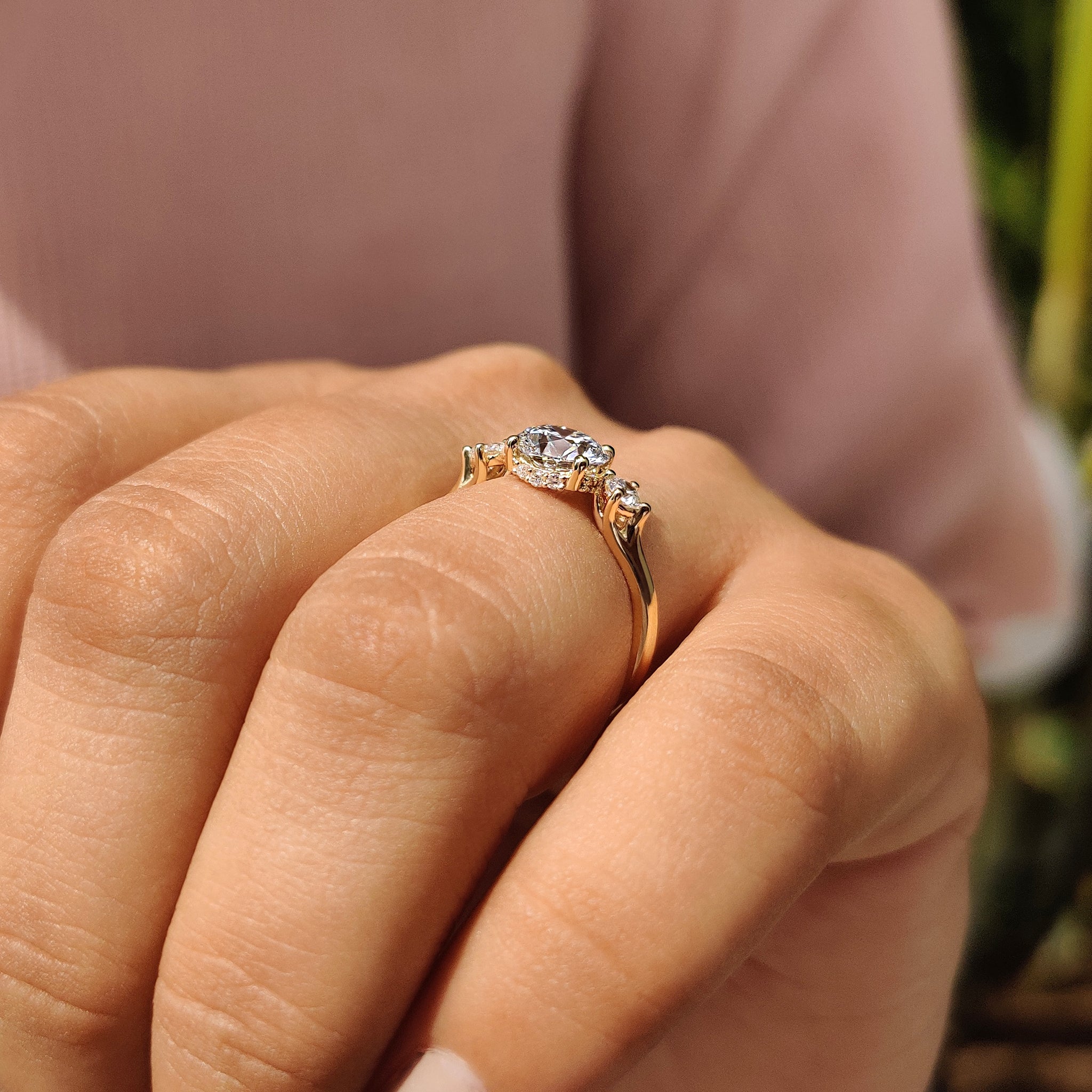 Handmade jewelry with hidden halo and round diamond center.