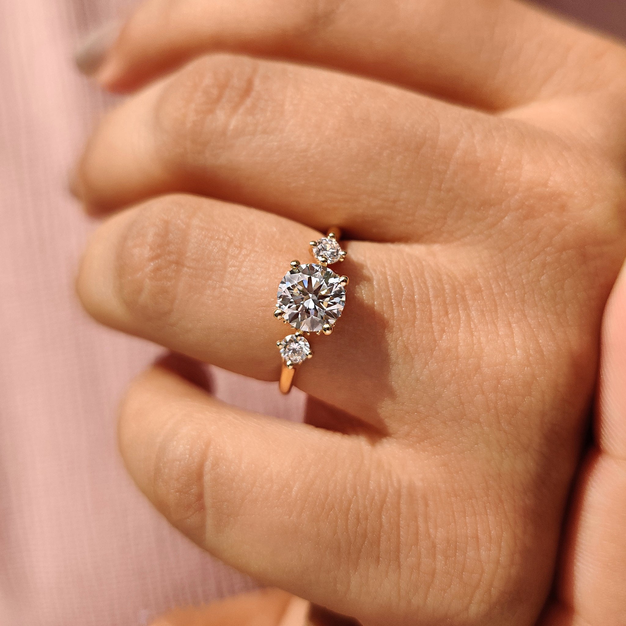 Four prong setting holding a round diamond in custom engagement ring.