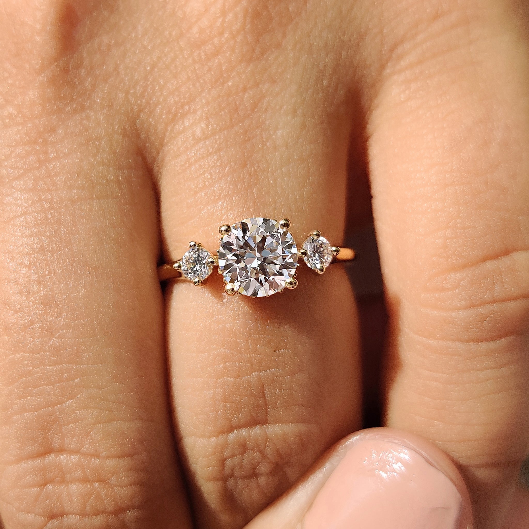 Hidden halo round engagement ring with round diamond center stone.
