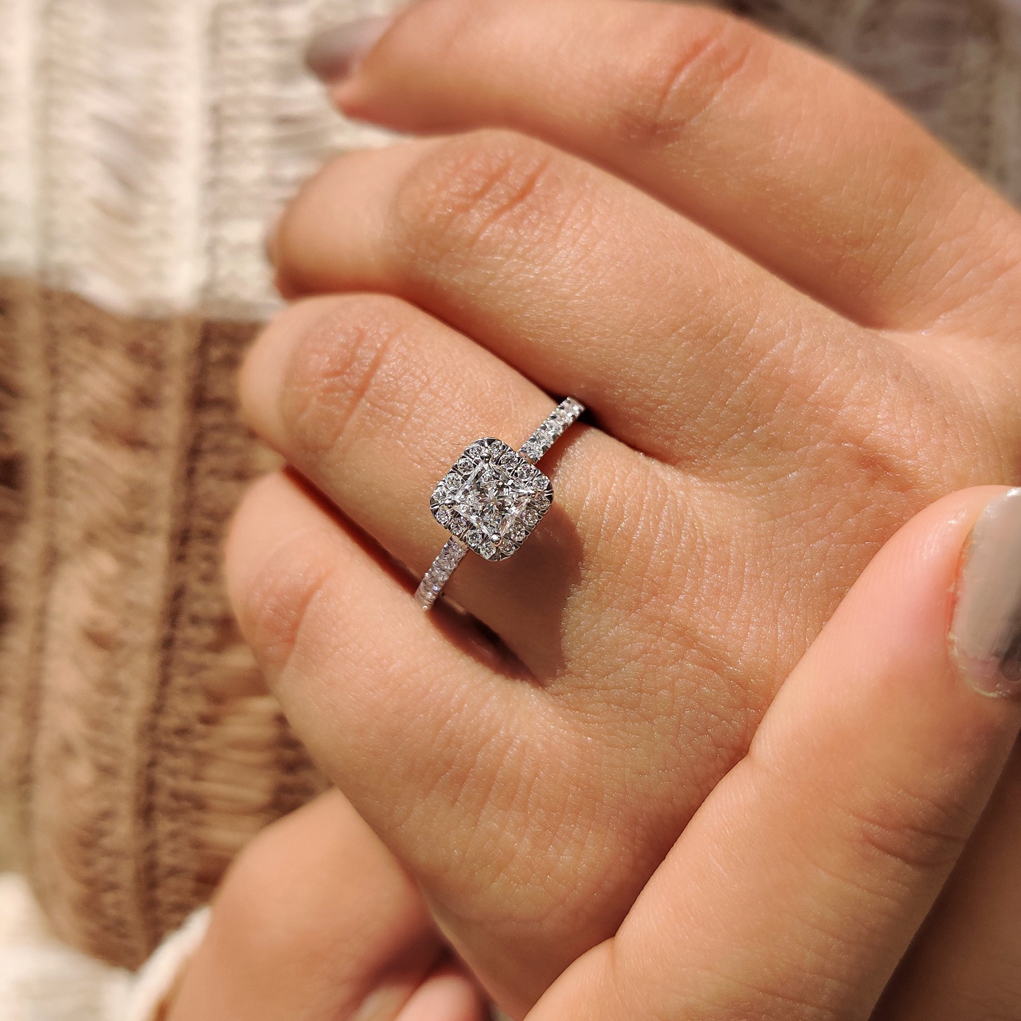 Halo setting with princess cut diamond and round cut pave band.
