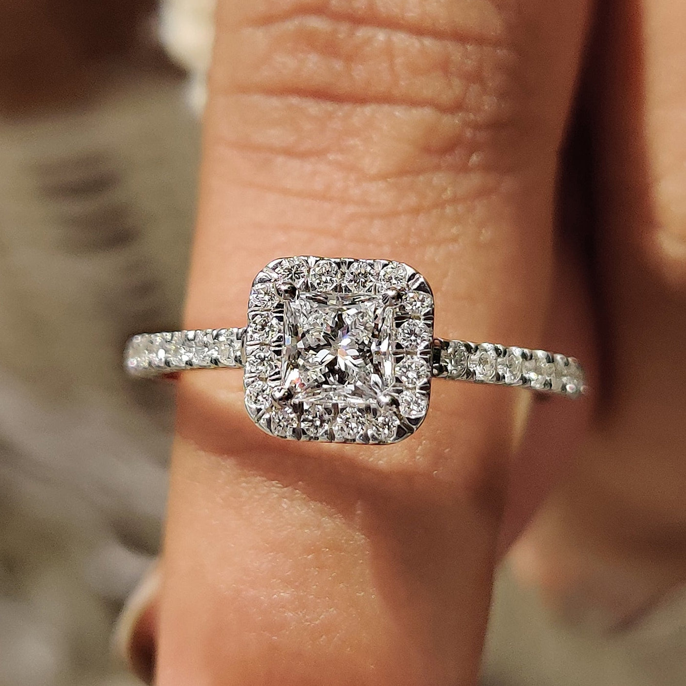 Custom engagement ring featuring a round cut pave band and cathedral setting.
