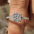 Custom engagement ring featuring a round cut pave band and cathedral setting.
