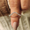 Marquise and round wedding band with shared prong setting.
