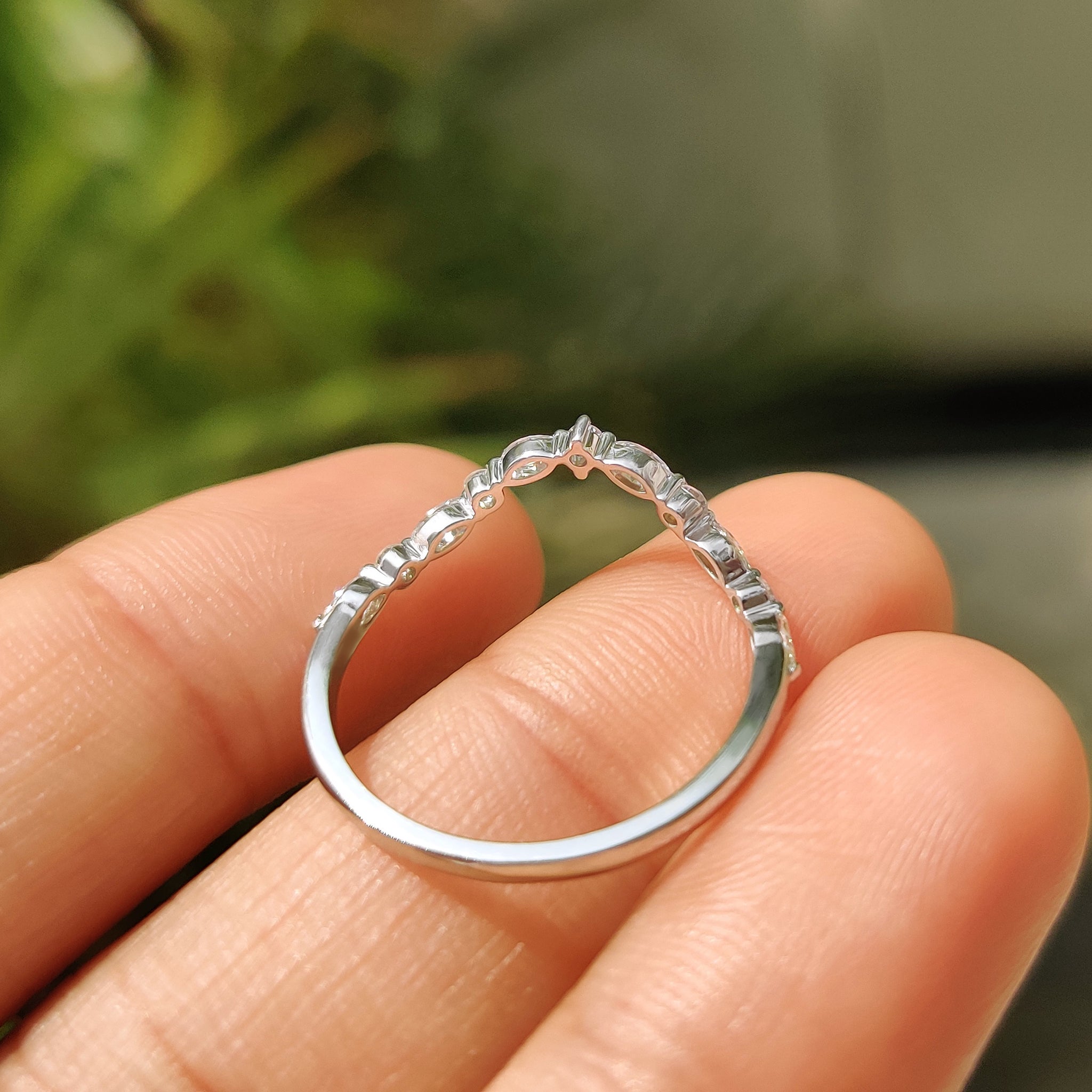 White gold wedding band with marquise and round stones.
