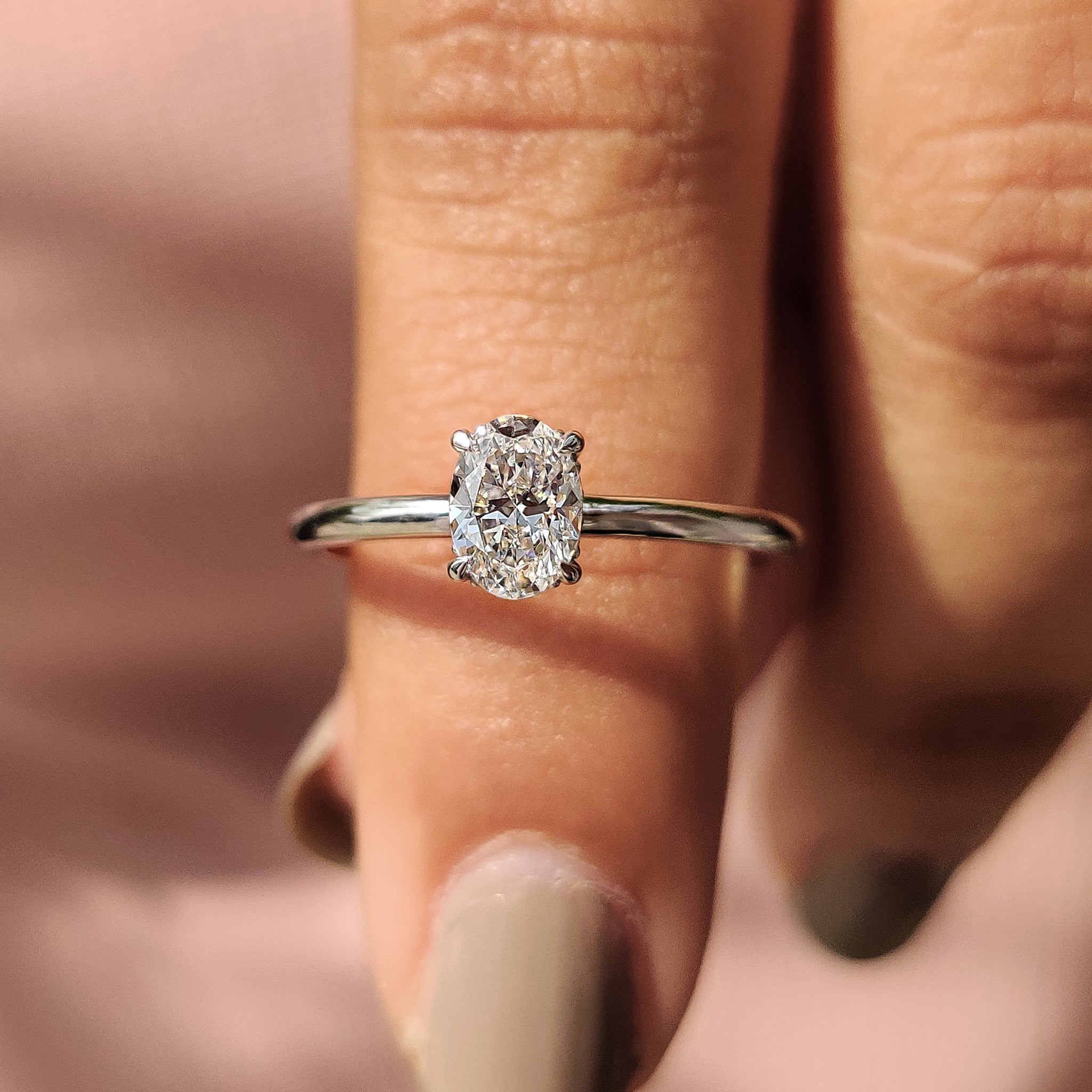 Oval solitaire engagement ring with solitaire setting ring.
