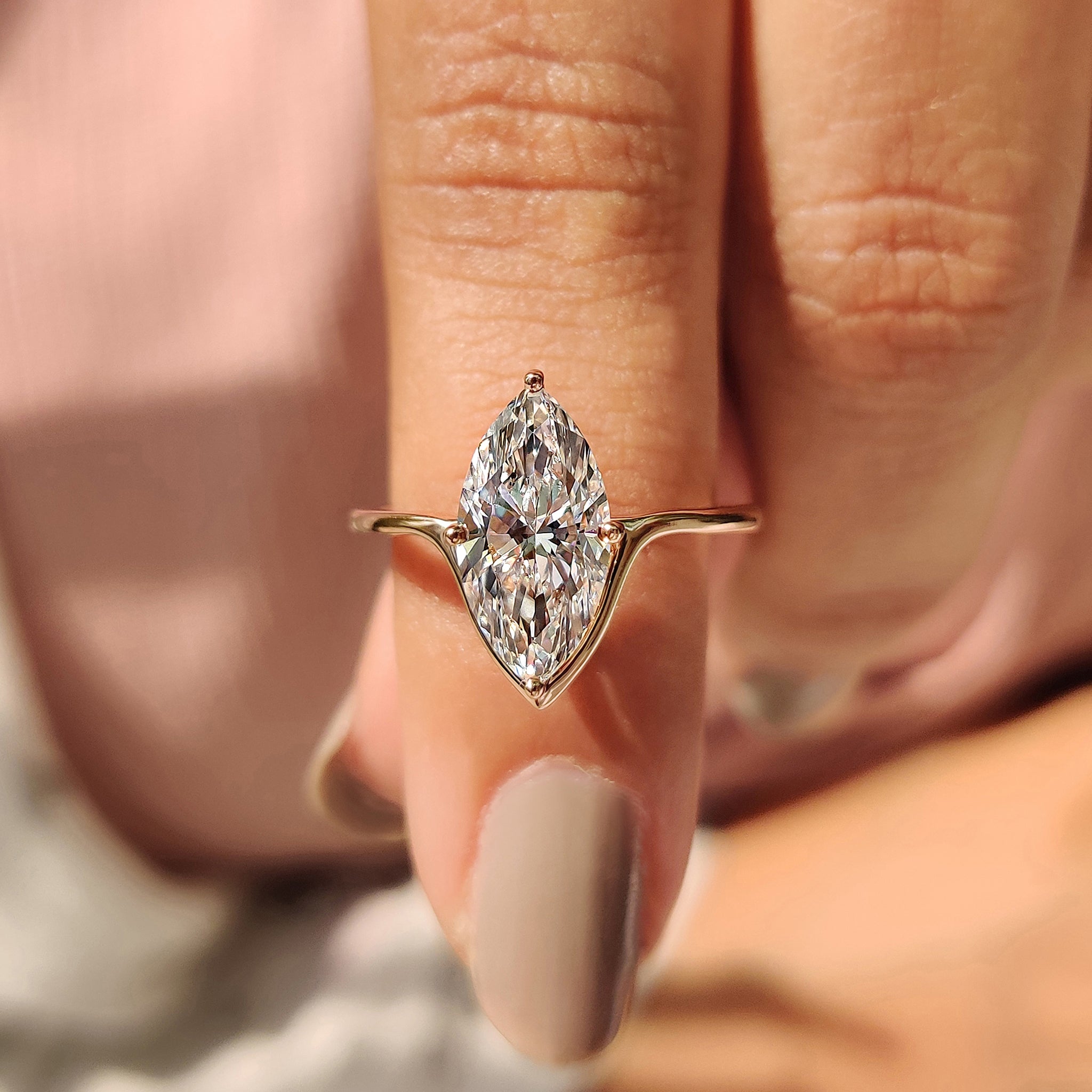 Marquise cut engagement ring with compass prong setting.
