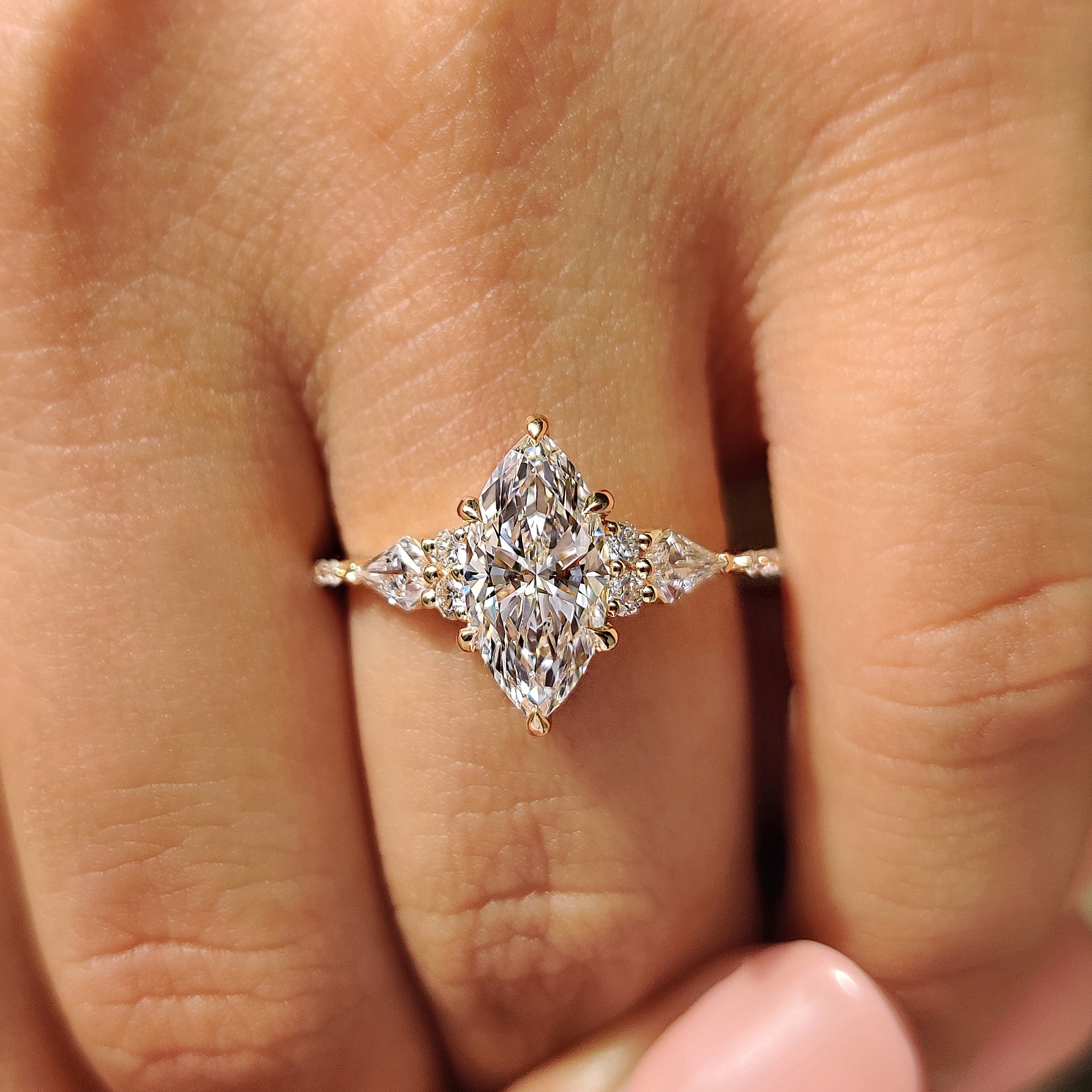 Kite and round side stone with yellow gold engagement ring.
