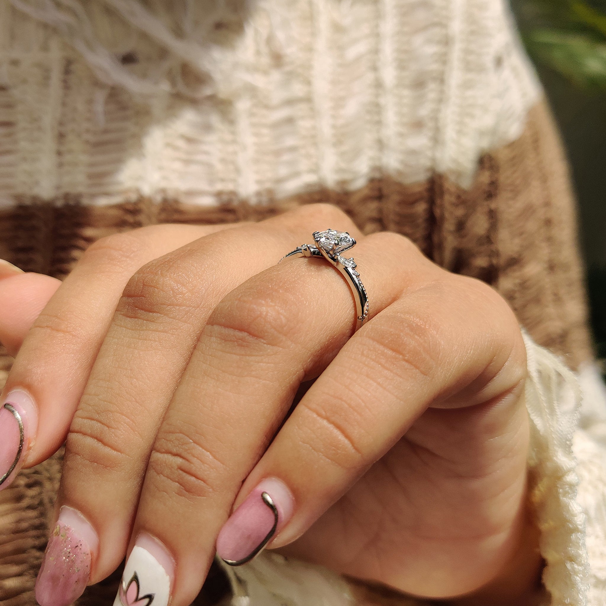 6 claw prong setting with marquise and round side stone.
