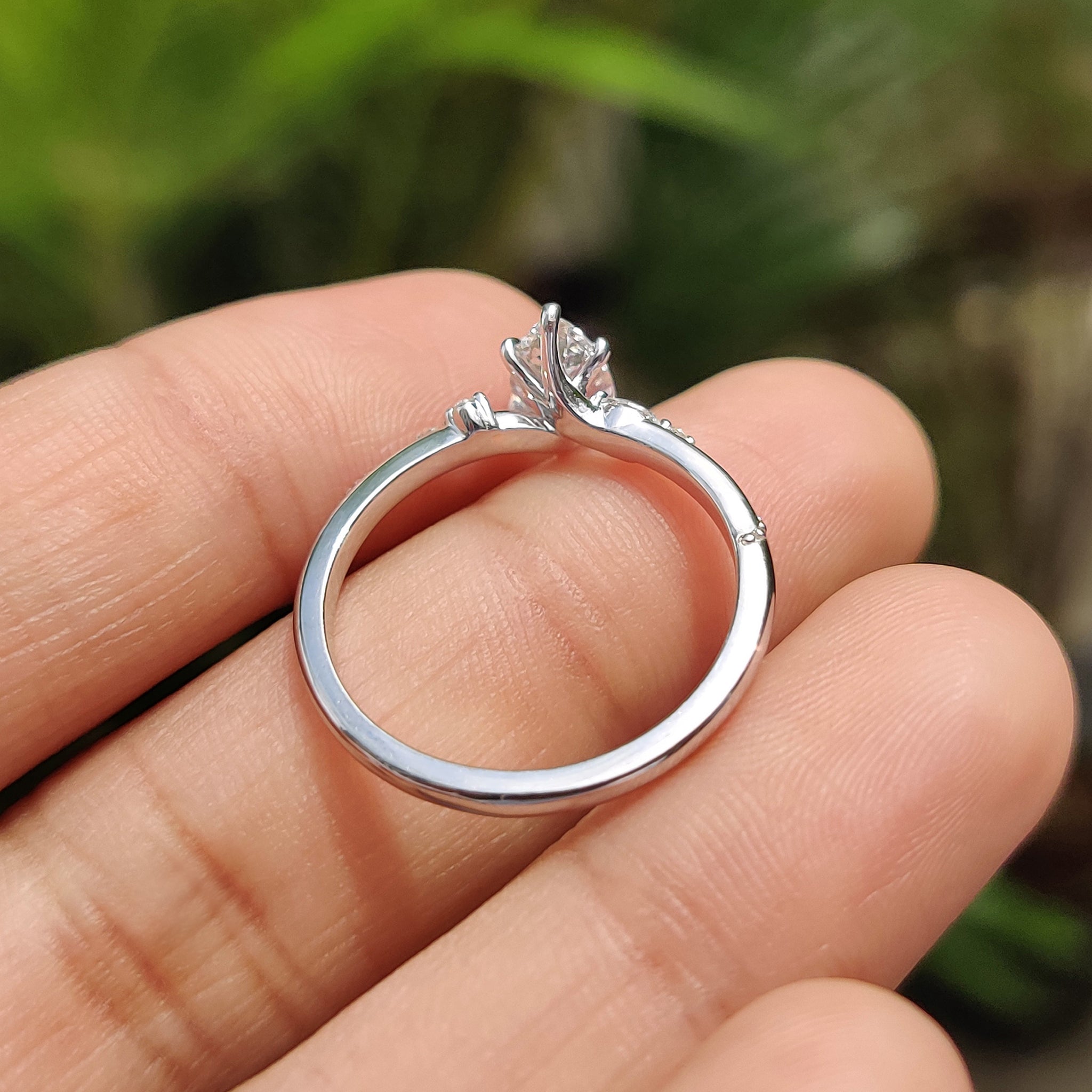 Marquise and round side stone in white gold engagement ring.
