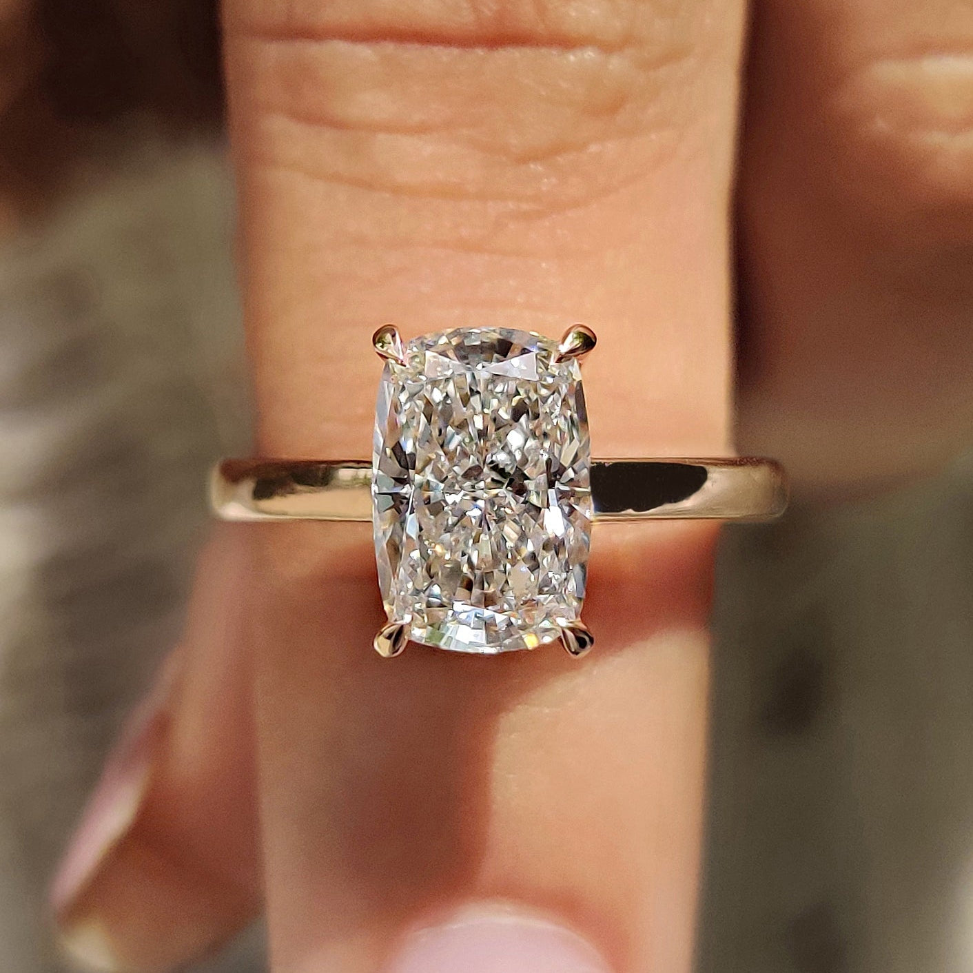Cushion cut diamond engagement ring with solitaire diamond ring.
