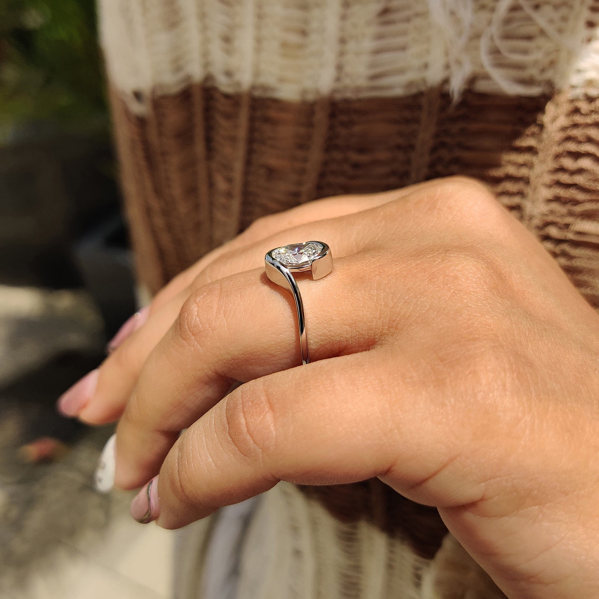 Unique engagement ring with hidden aquamarine diamond and half bezel setting.
