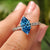 Marquise diamond engagement ring with blue marquise diamond.