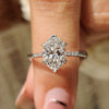 Oval cut diamond engagement ring with tapered shank ring.