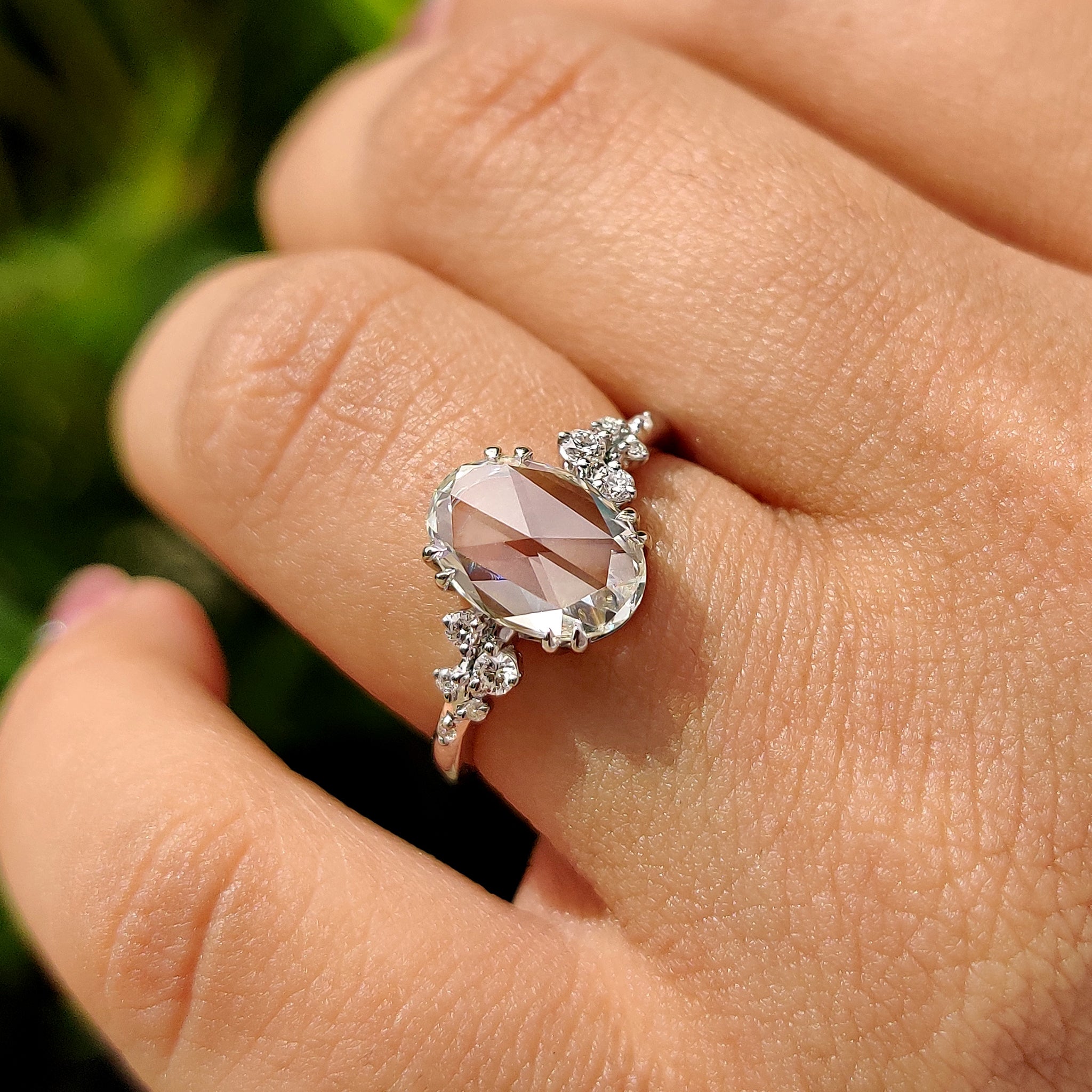 Oval rose cut engagement ring with cluster diamond ring.
