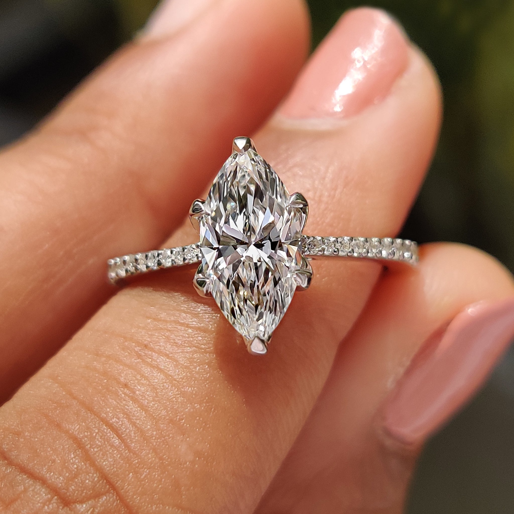 Marquise diamond engagement ring with tapered shank ring.