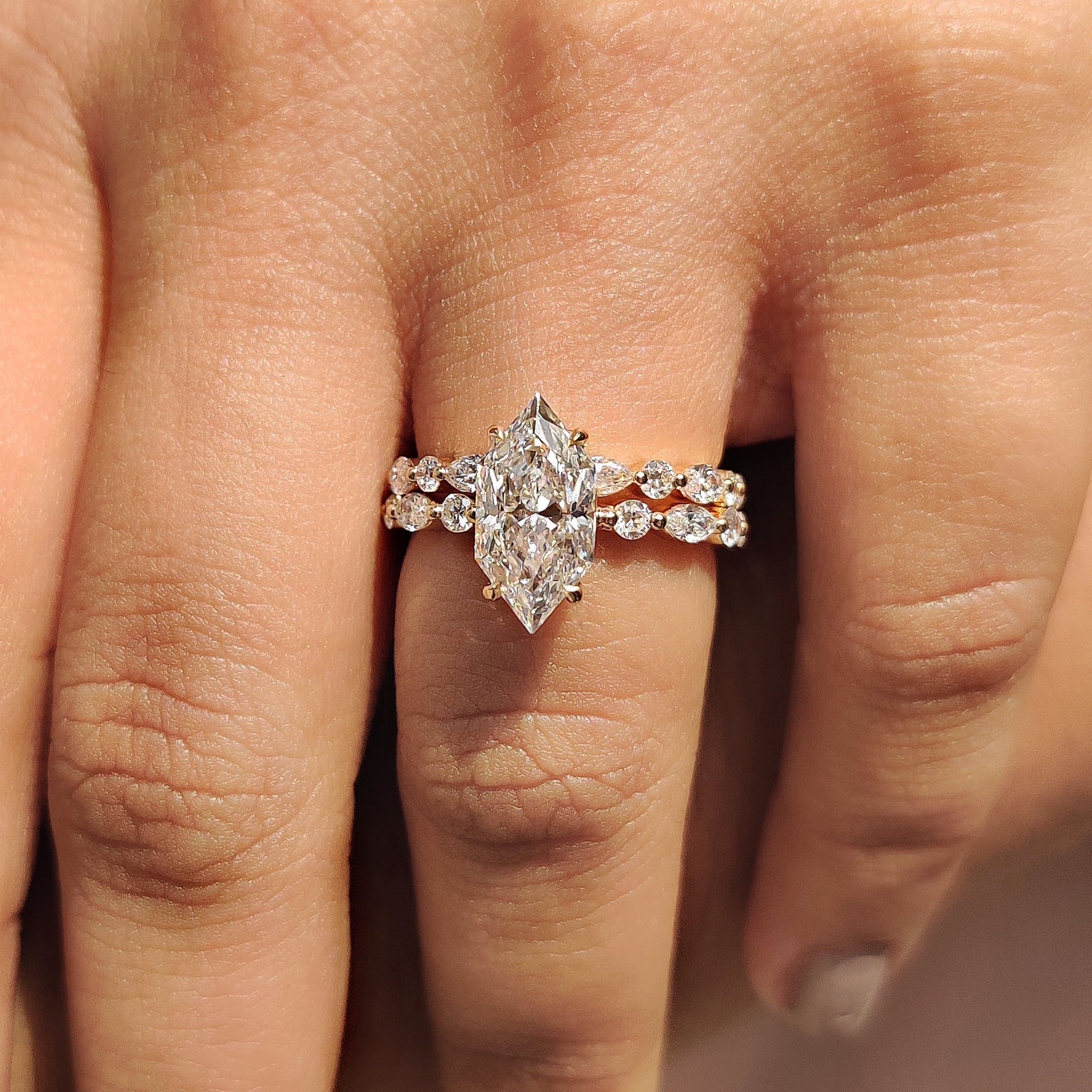 Shared prong band with marquise and round diamond band.