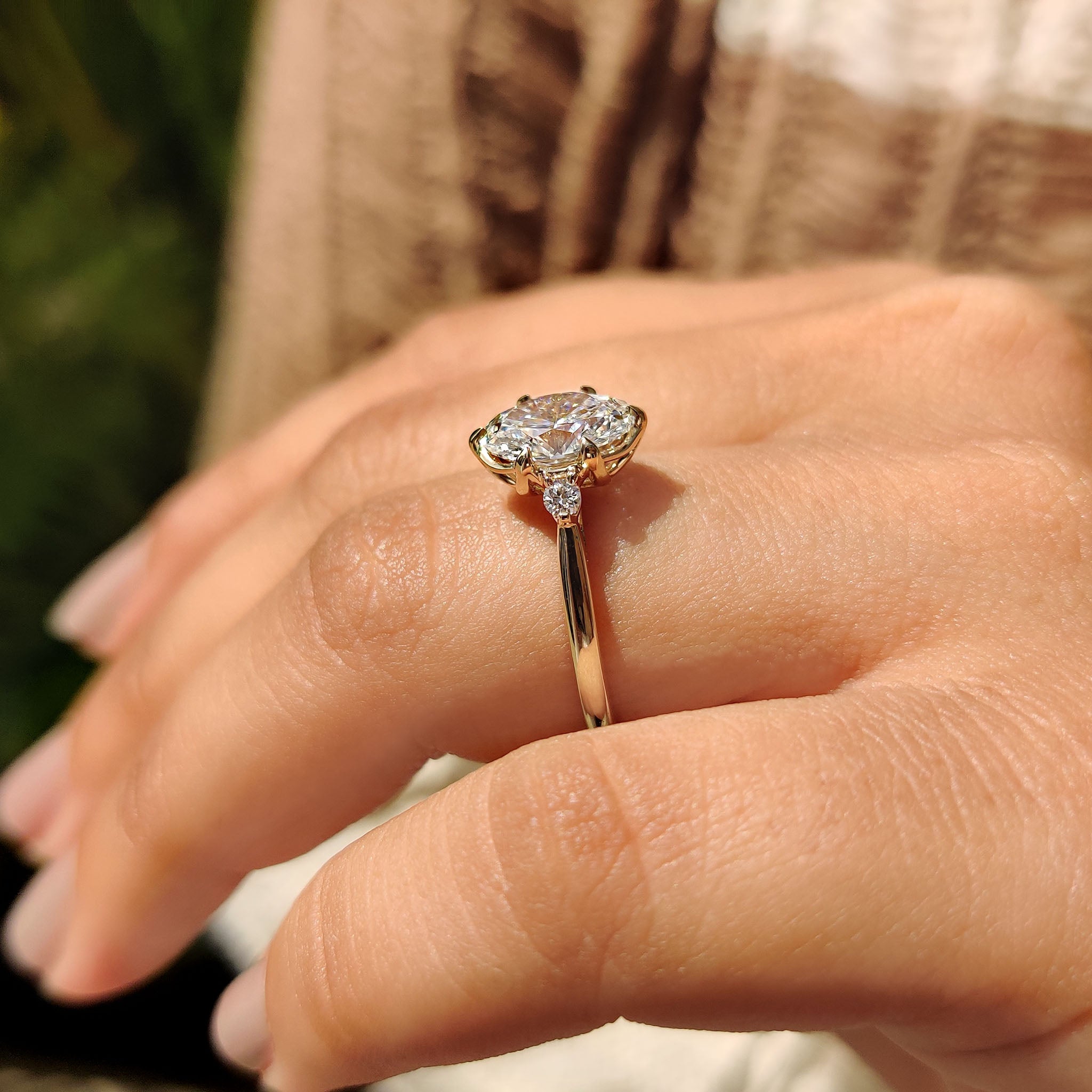 Oval diamond engagement ring with round cut side stones.