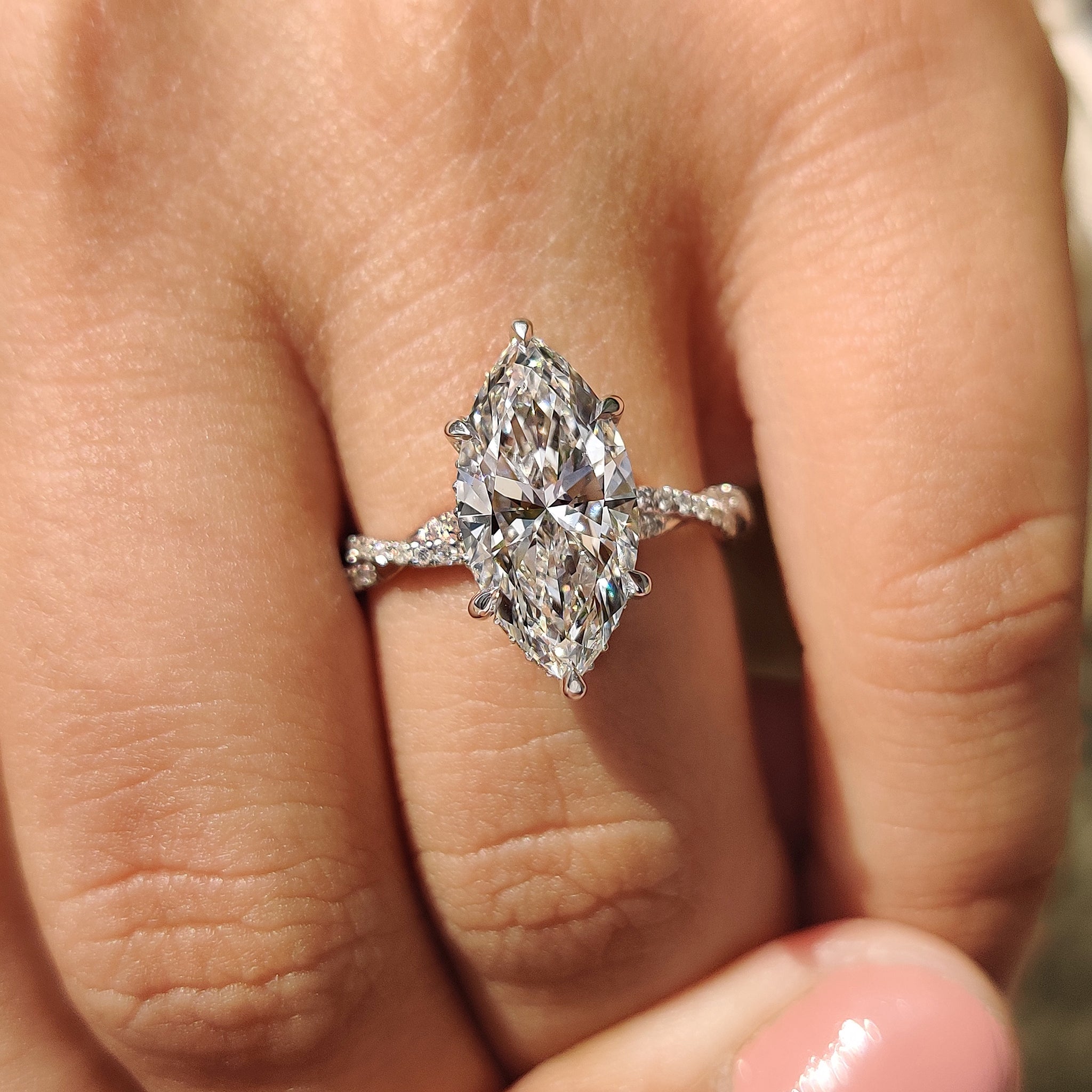 Twisted pave ring with round cut twisted diamond.
