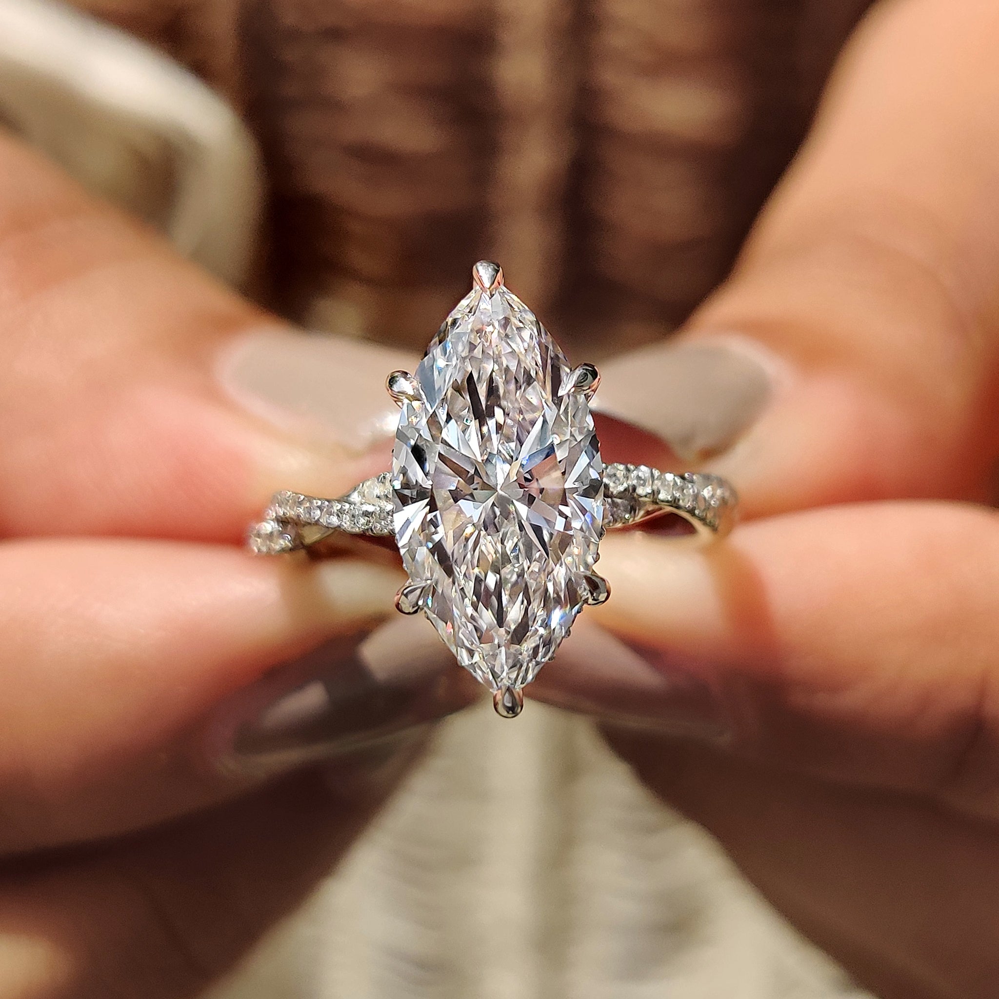 Marquise cut engagement ring with twisted pave ring.