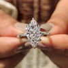 Marquise cut engagement ring with twisted pave ring.