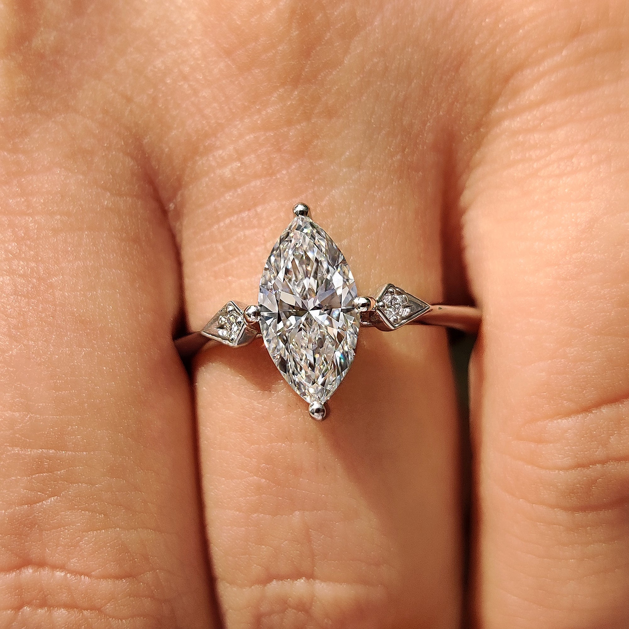 Three stone engagement ring with compass prong setting.