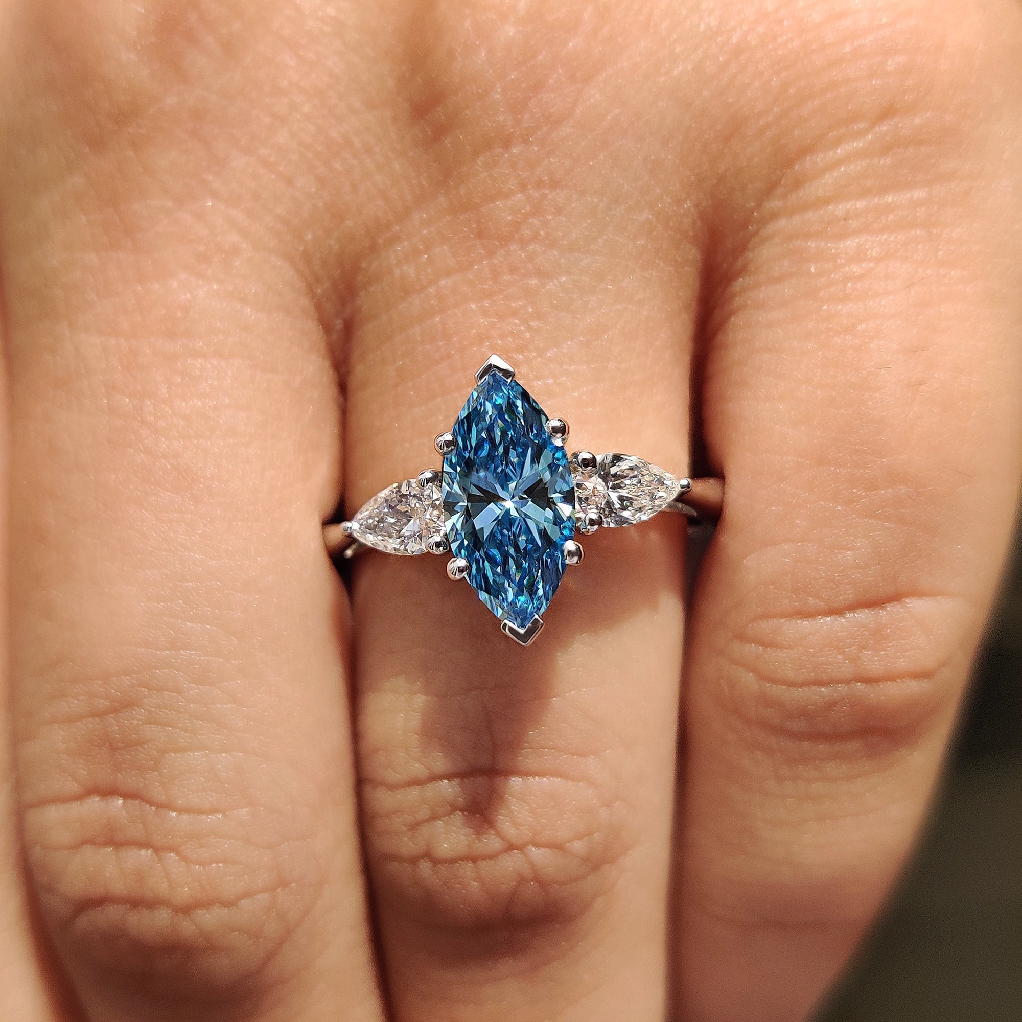 Pear side stone with white gold diamond ring.