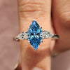 Marquise cut diamond engagement ring with blue marquise ring.
