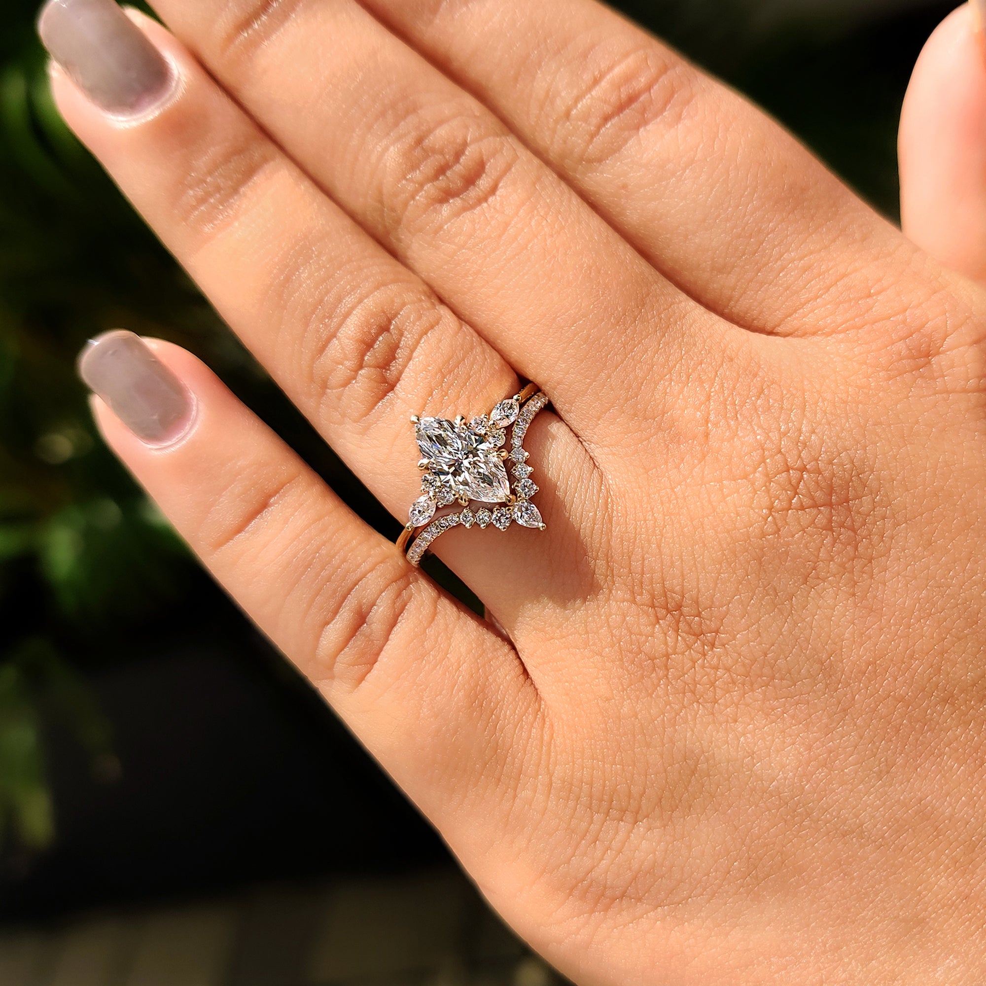 Pear and round diamond band paired with marquise ring bridal set.