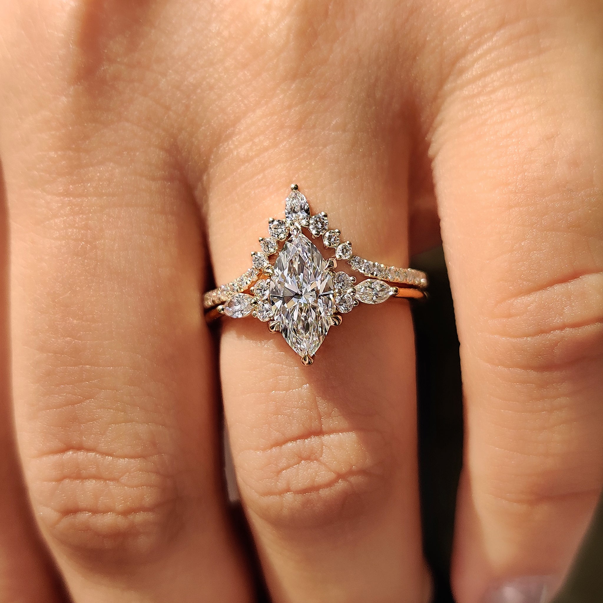 V shaped wedding band with pear and round diamond design.