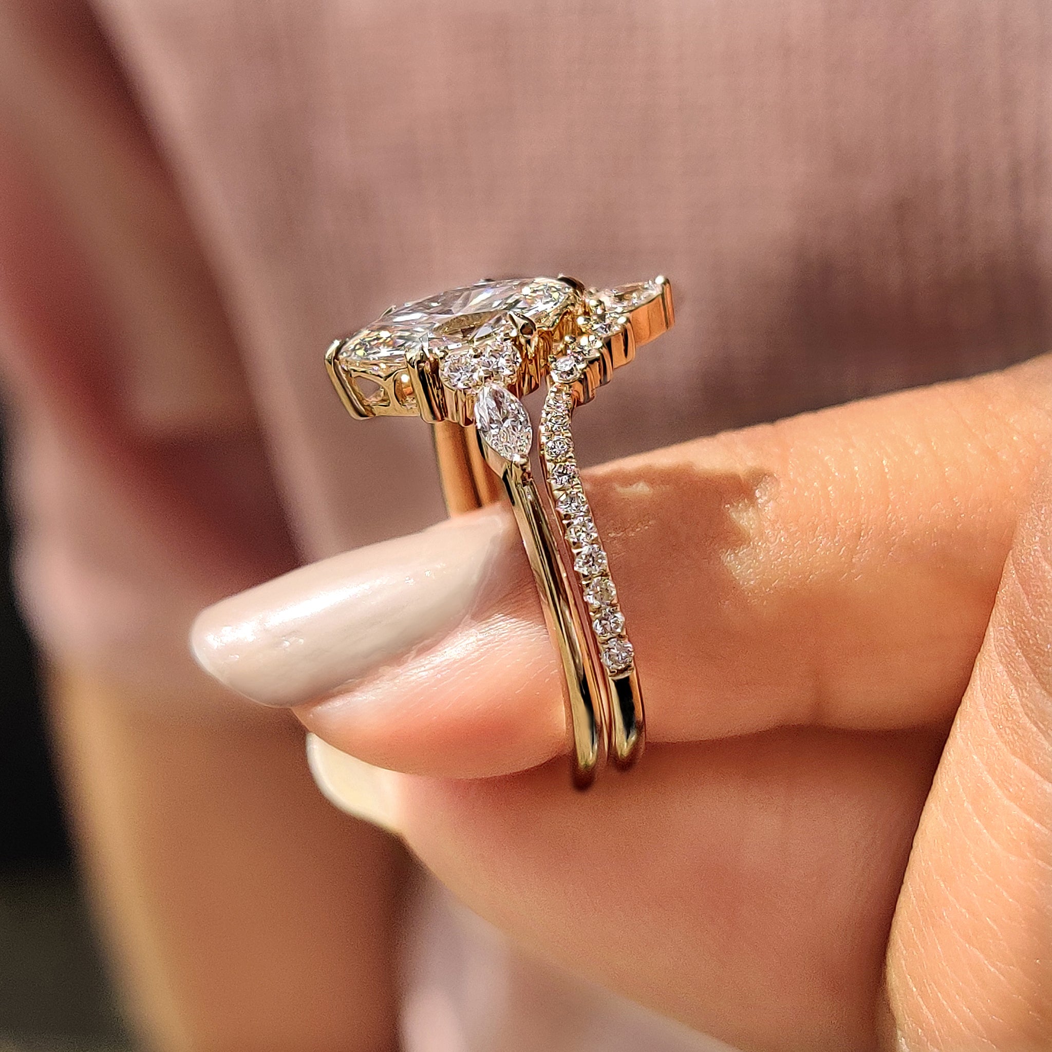 Handmade bridal set featuring marquise and round side stone ring.