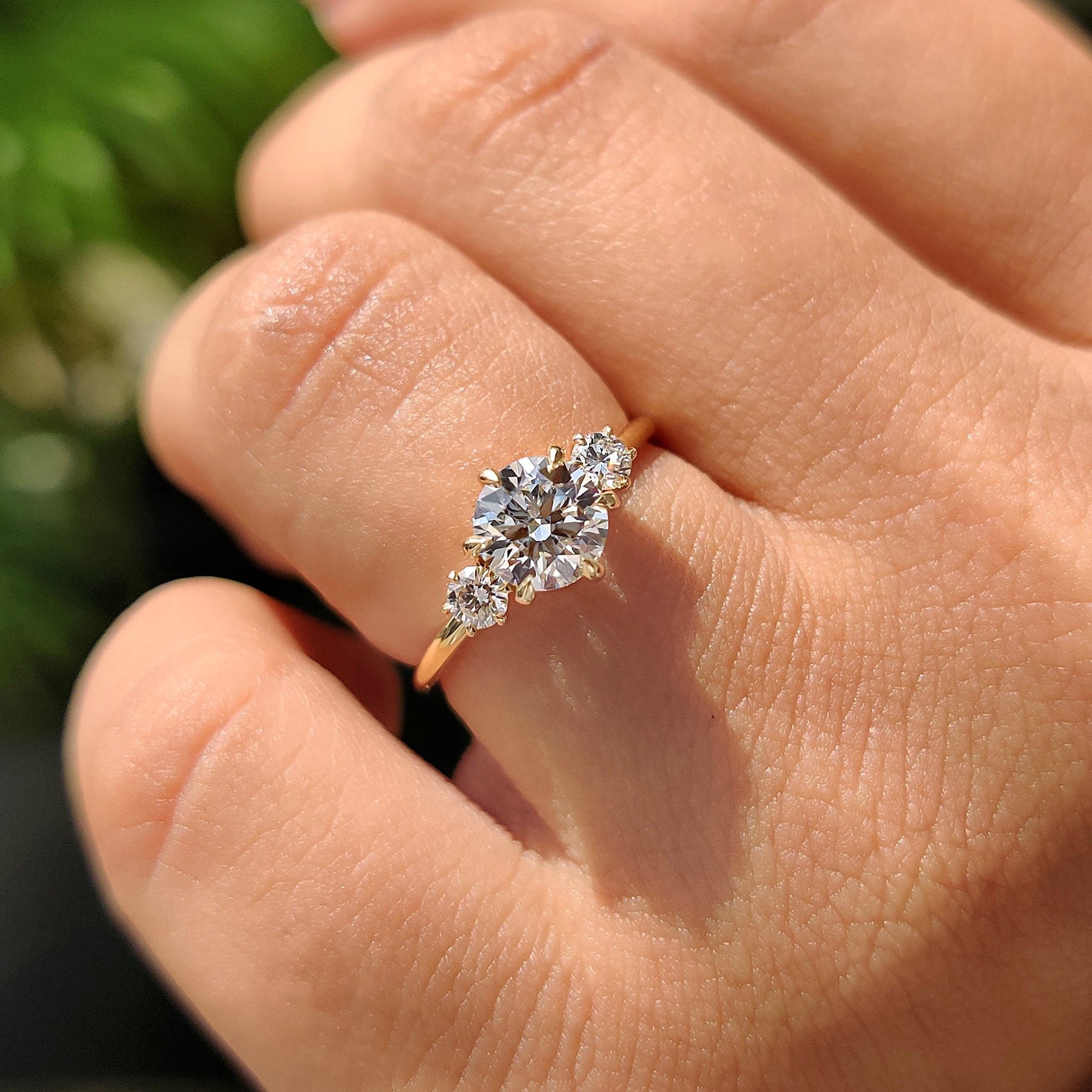 Carat diamonds ring in three stone round engagement ring.
