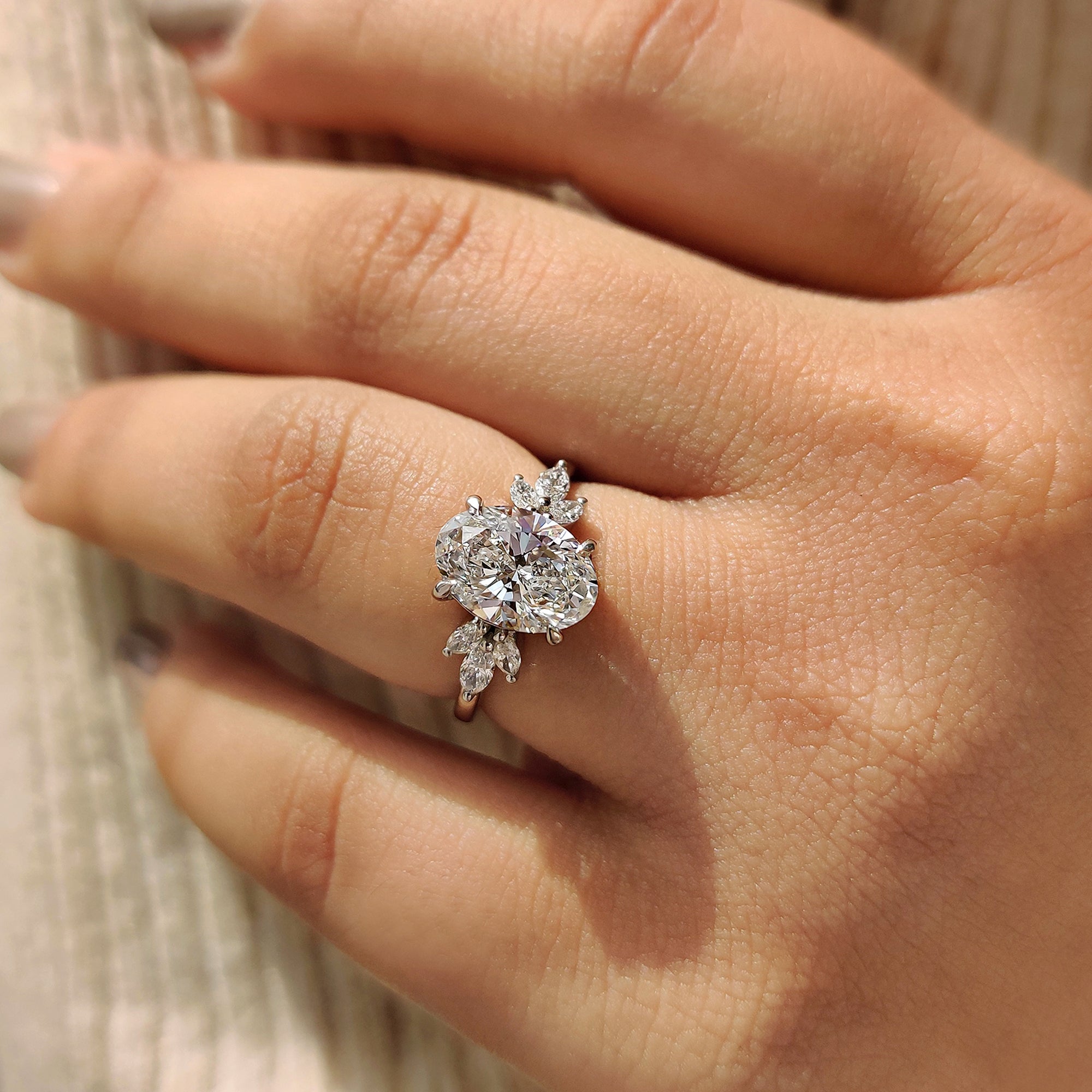 Hidden halo engagement ring with marquise side stones.
