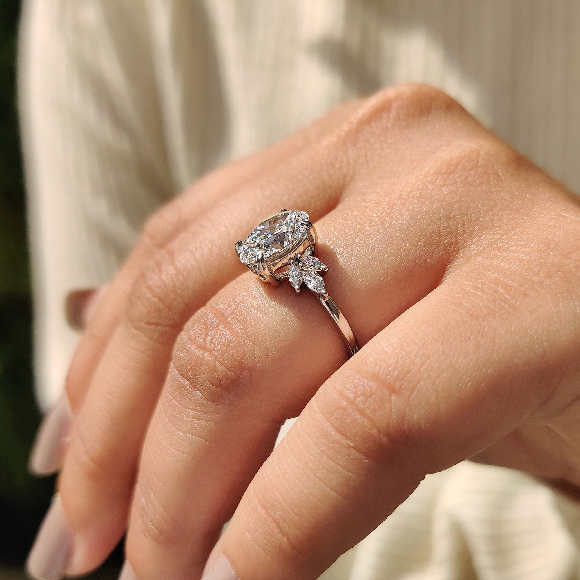 White gold engagement ring with marquise side stones.
