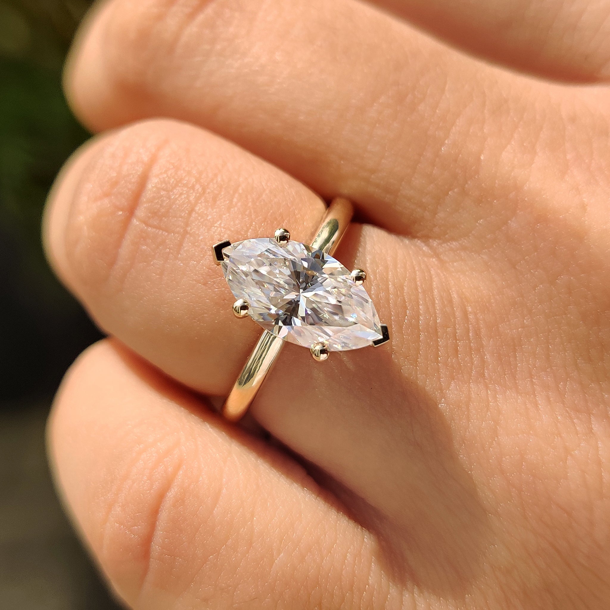 Moissanite engagement ring in v prong setting.