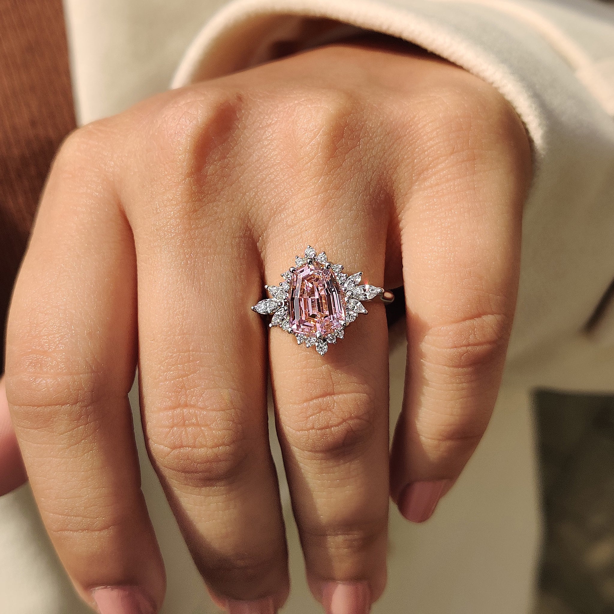 Shield cut engagement ring with marquise and round side stone.