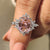 Pink gemstone ring with marquise and round side stone.