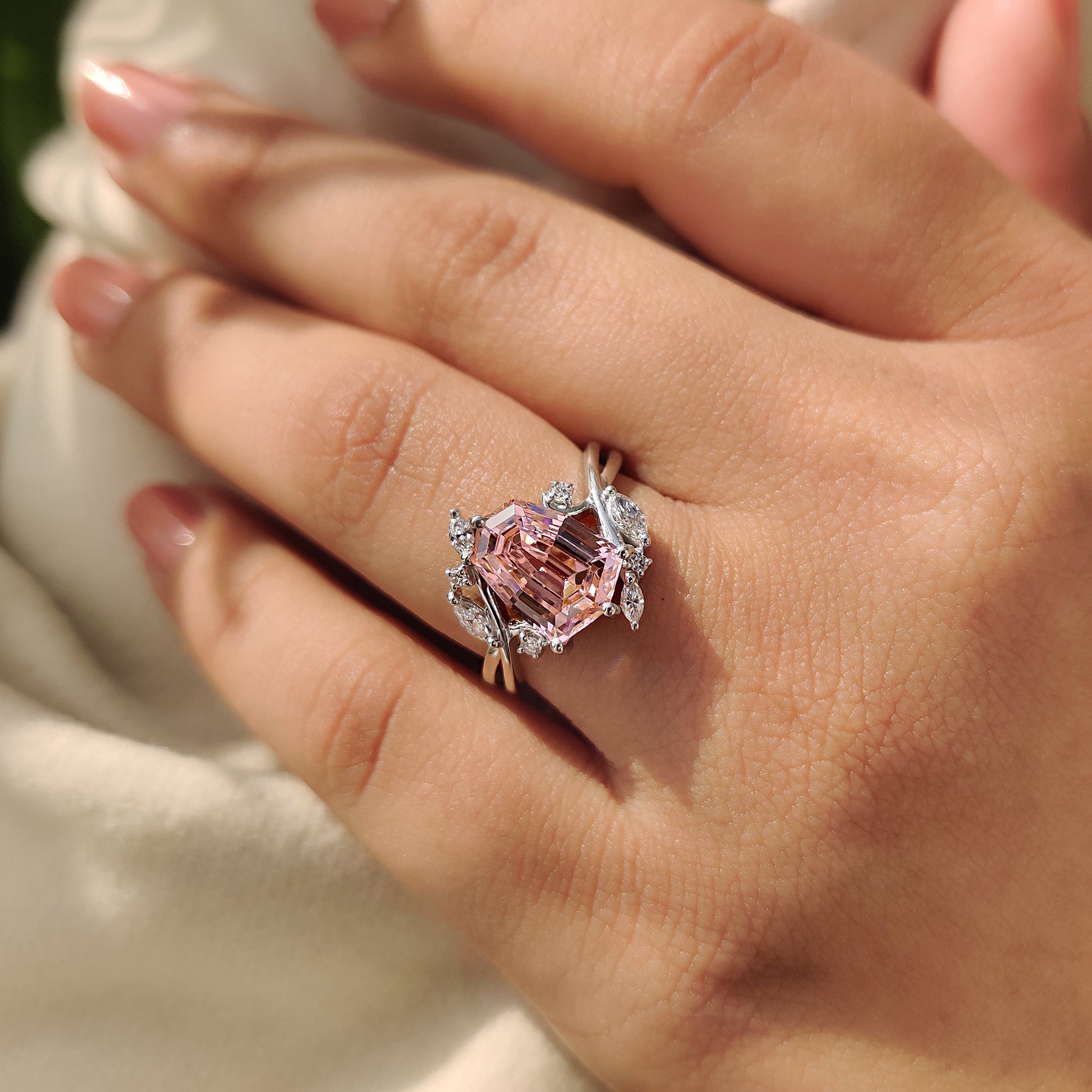 White gold engagement ring with pink gemstone design.