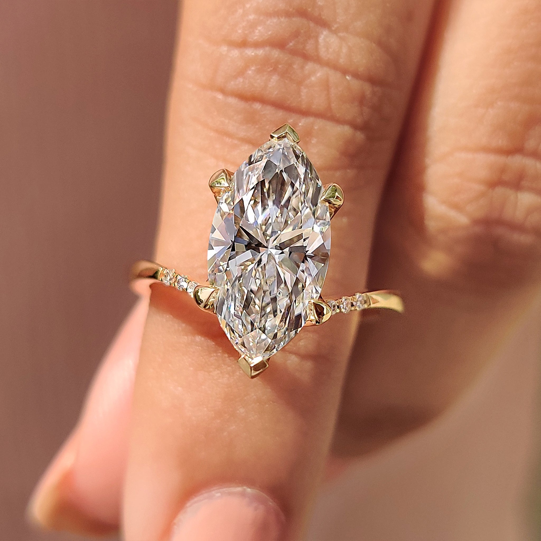 Gold marquise engagement ring with tapered band